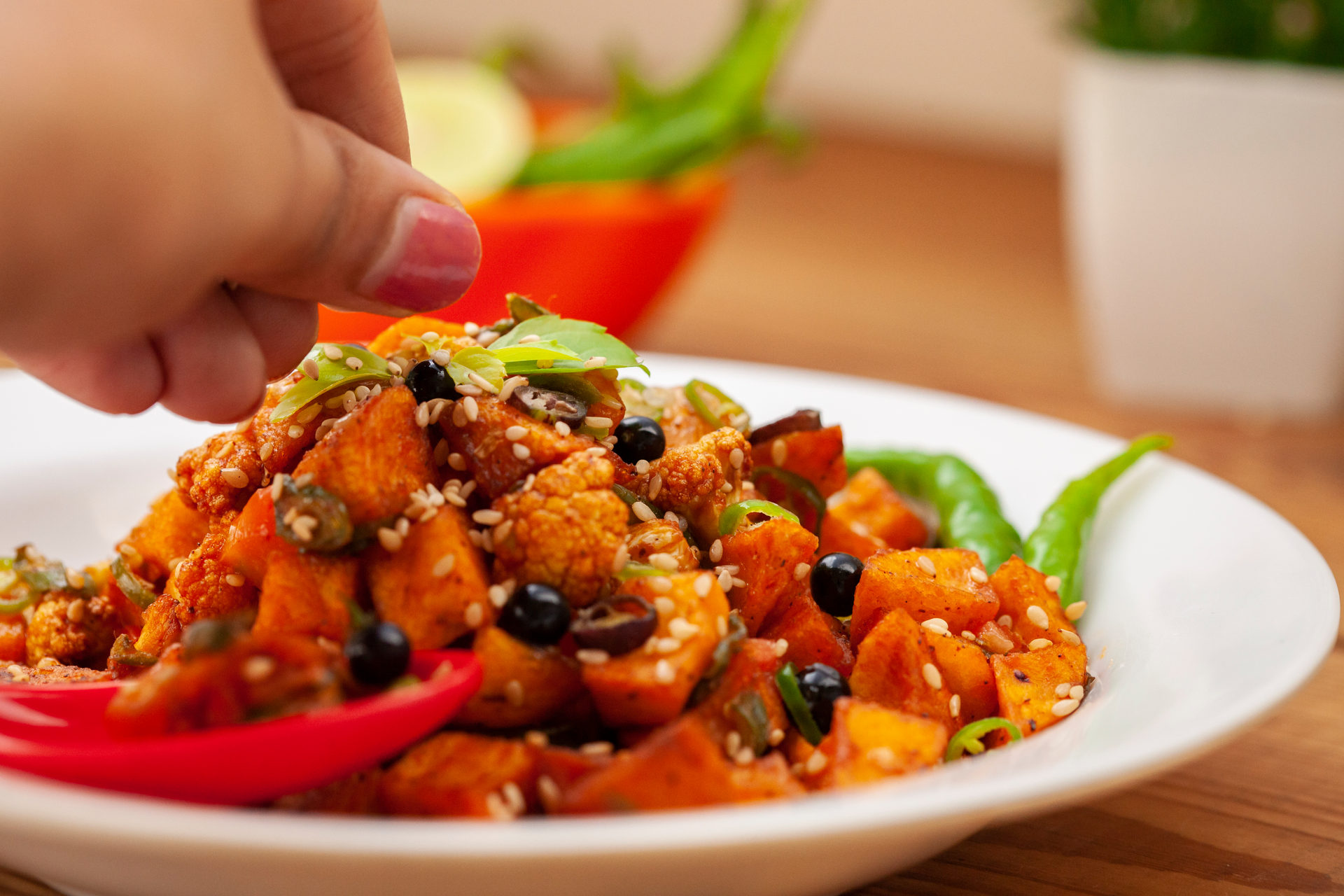 Overhead flat-lay of all ingredients for African Ndolé with Crushed Peanuts and Spicy Prawns laid out on a kitchen surface.