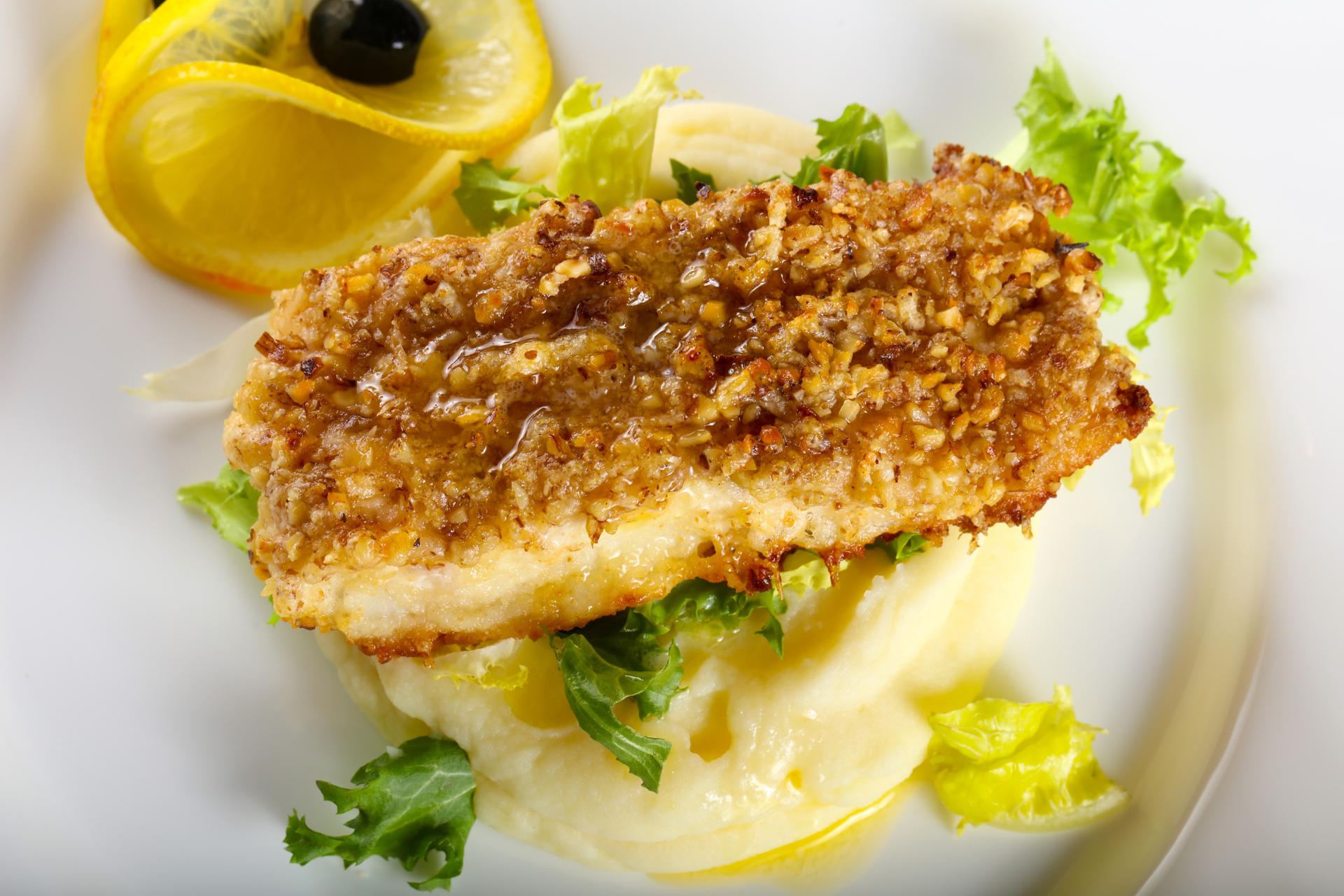 Overhead flat-lay of all ingredients for Almond-Crusted French Sole Meunière with Lemon Butter Sauce laid out on a kitchen surface.