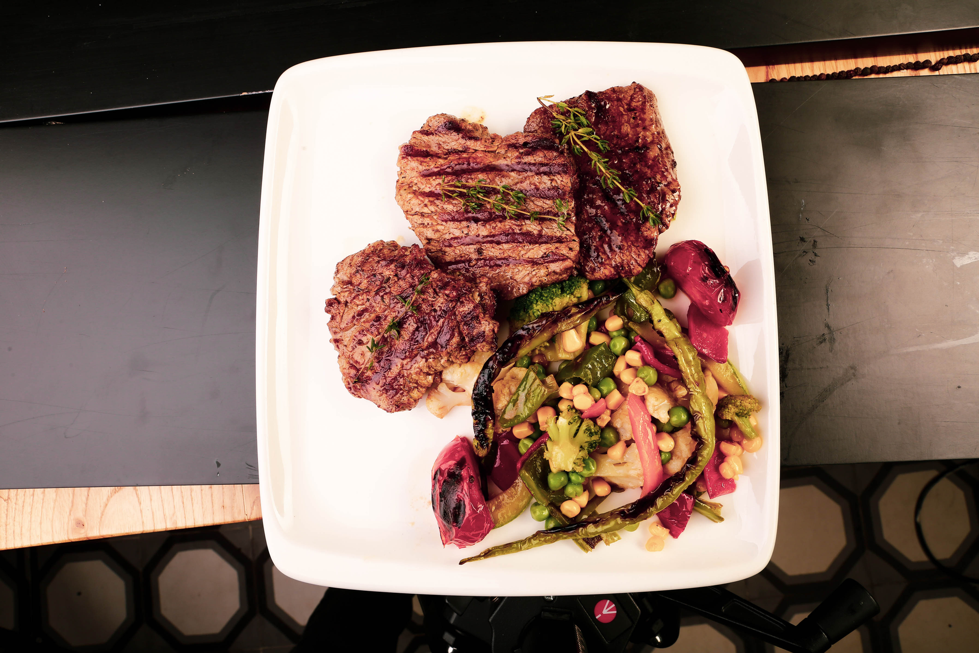 Overhead flat-lay of all ingredients for Argentine Chimichurri Steak with Roasted Vegetables laid out on a kitchen surface.