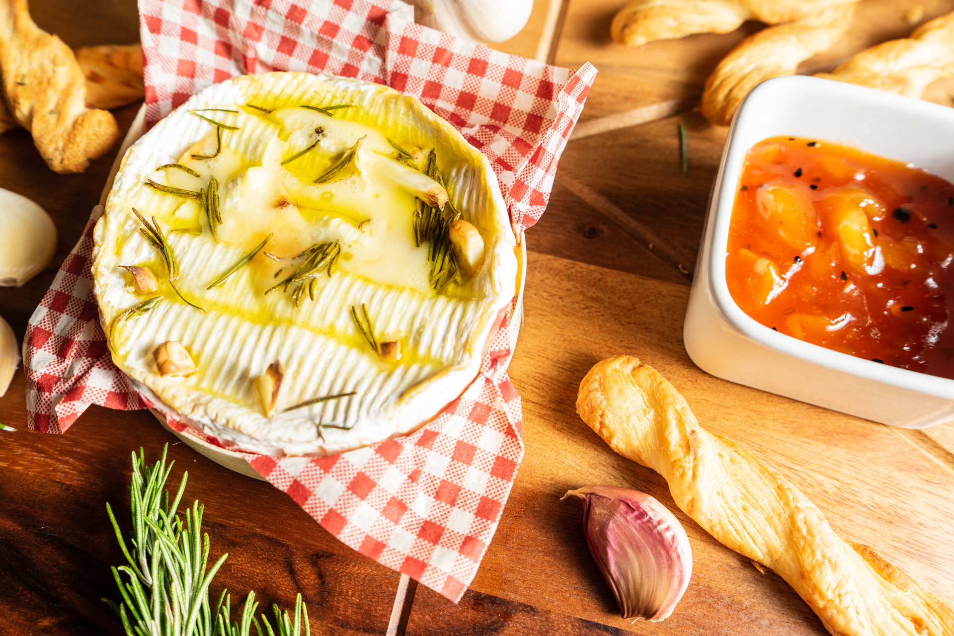 Overhead flat-lay of all ingredients for Argentine Provolone al Horno with Oregano and Olive Oil laid out on a kitchen surface.