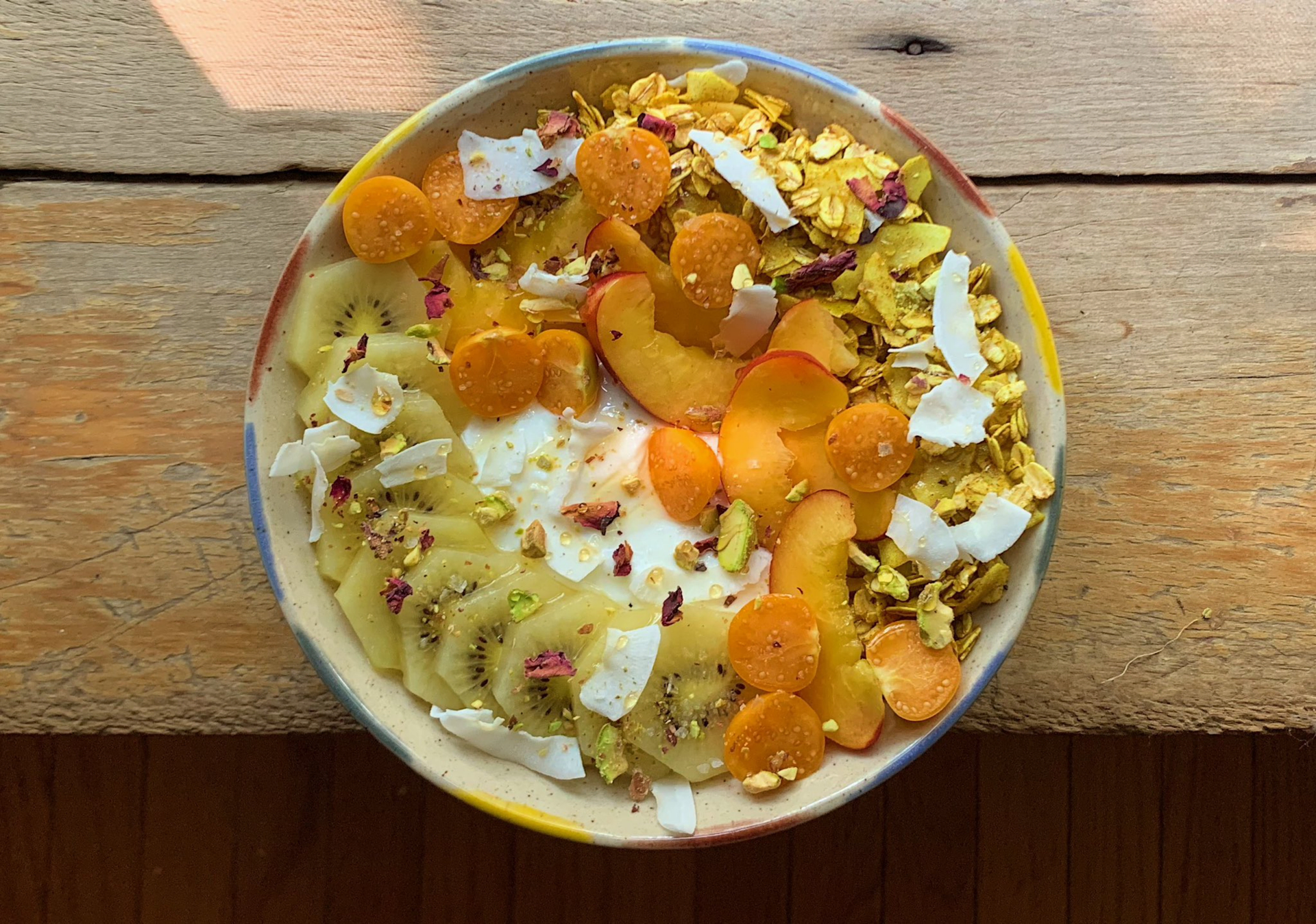 Overhead flat-lay of all ingredients for Armenian Apricot and Pistachio Couscous Pilaf with Toasted Almonds laid out on a kitchen surface.