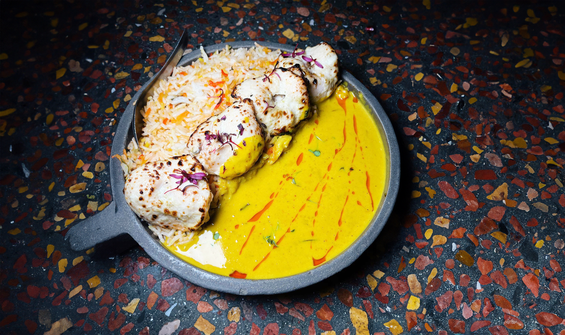 Overhead flat-lay of all ingredients for Aromatic Bangladeshi Chicken Rezala with Yogurt and Saffron laid out on a kitchen surface.