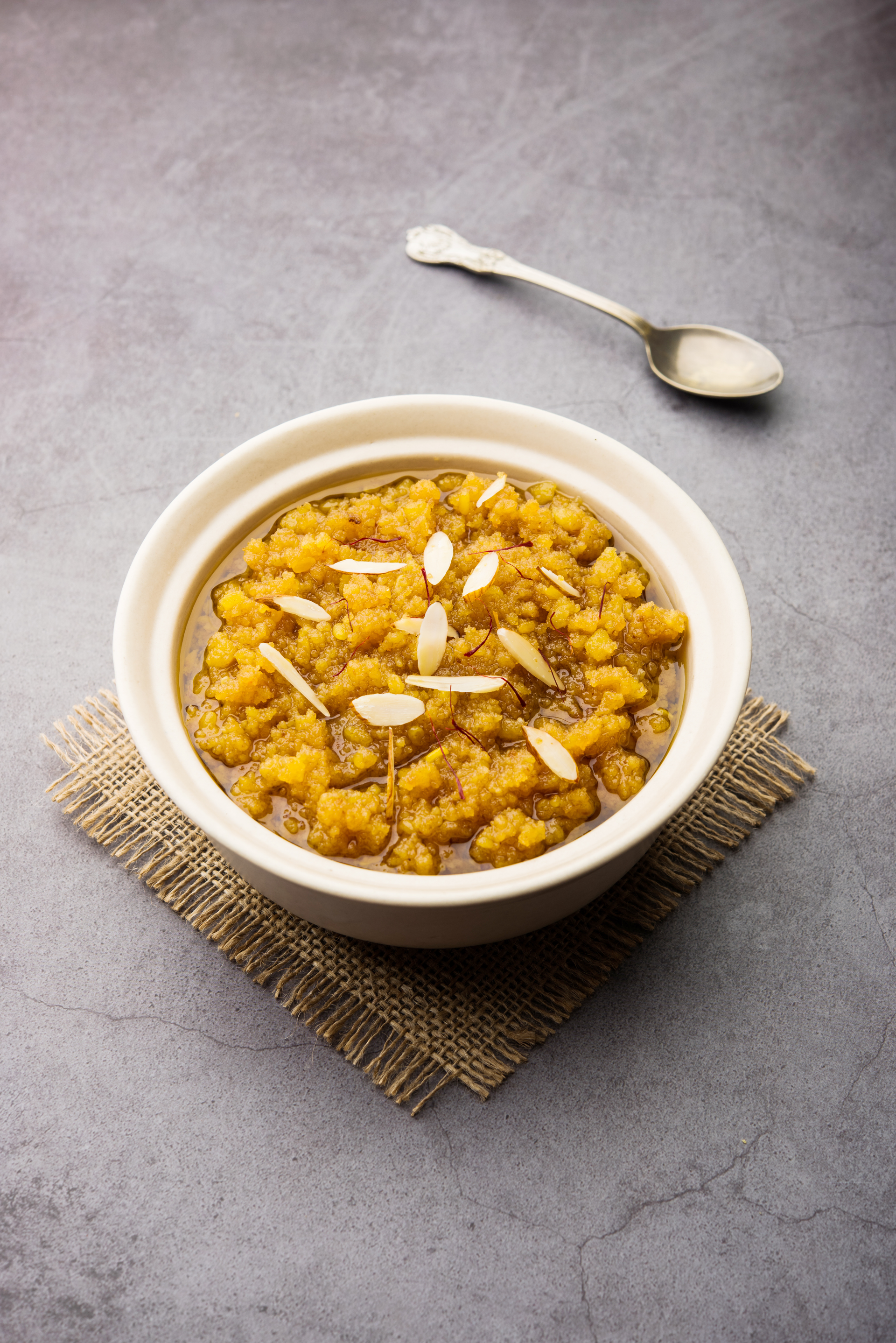 Overhead flat-lay of all ingredients for Aromatic Bengali Cholar Dal with Coconut and Golden Raisins laid out on a kitchen surface.