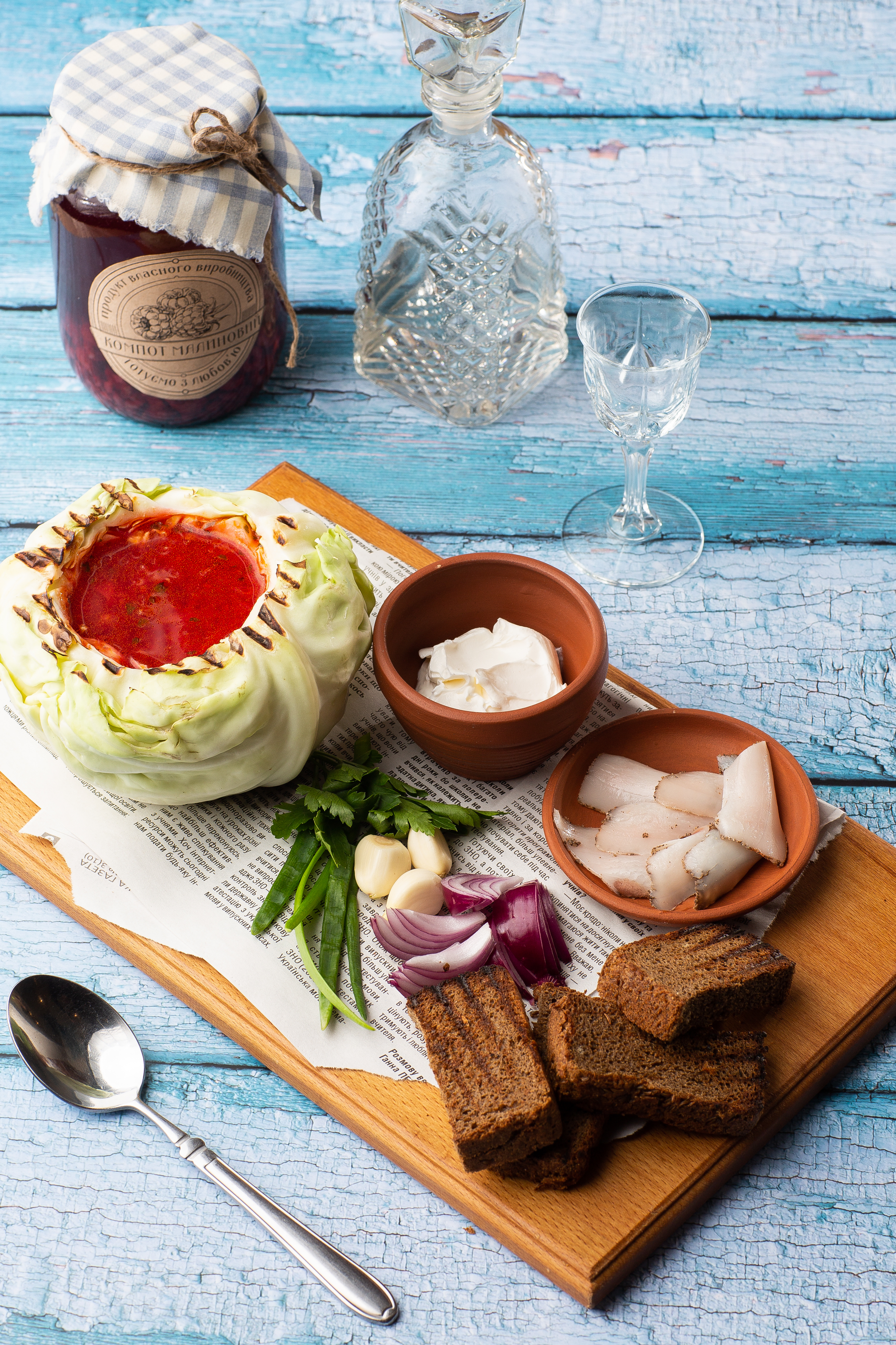 Overhead flat-lay of all ingredients for Aromatic Bulgarian Lyutenitsa laid out on a kitchen surface.