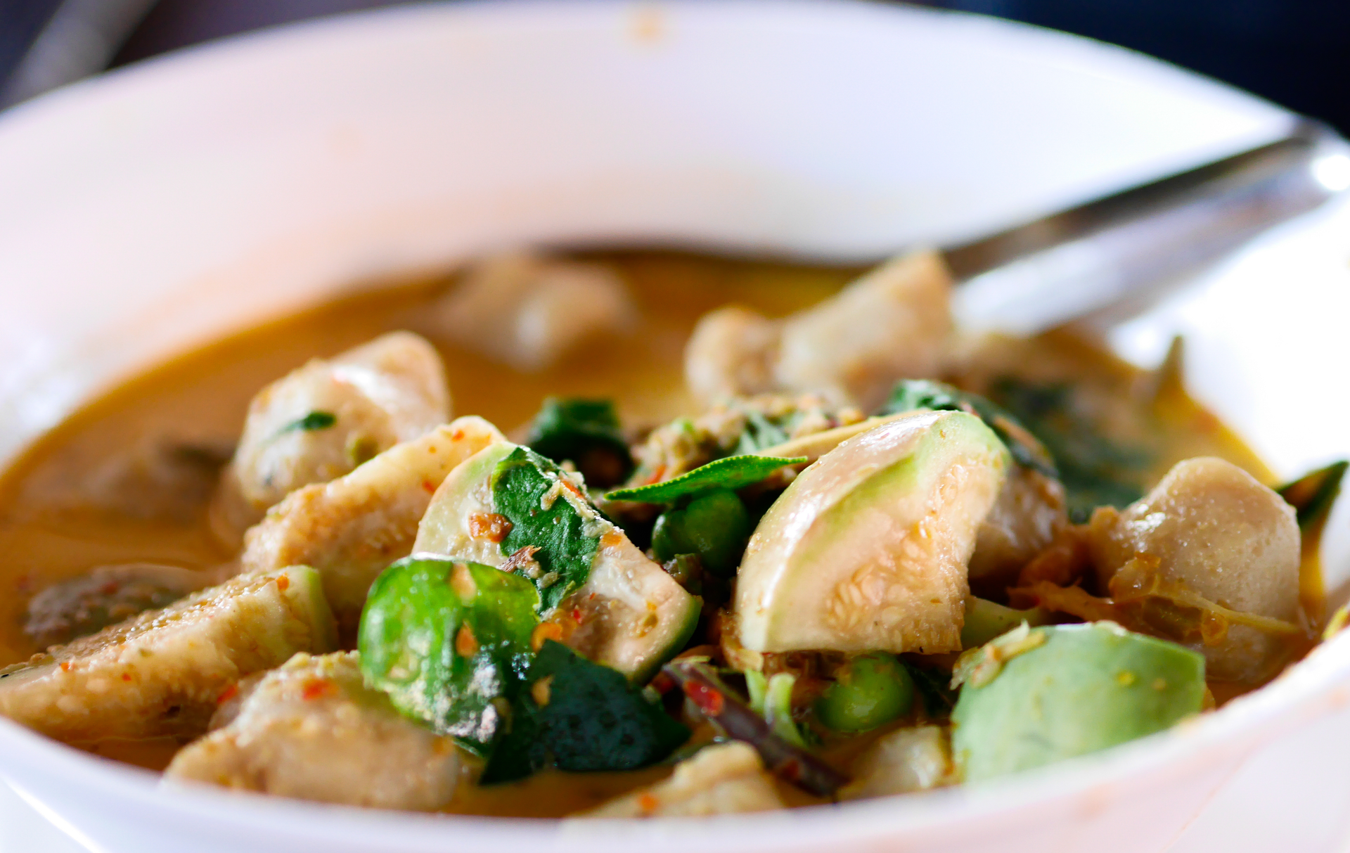 Overhead flat-lay of all ingredients for Aromatic Cambodian Lemongrass Chicken Curry laid out on a kitchen surface.