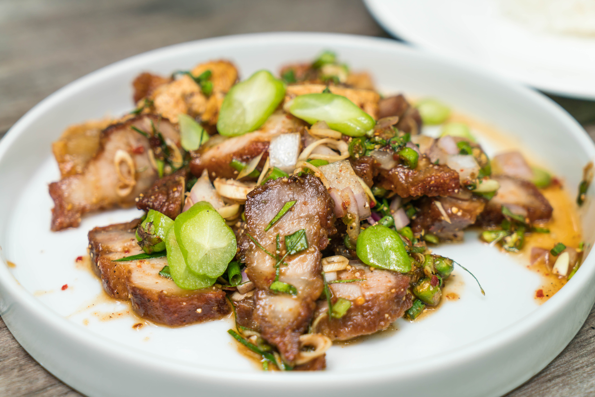 Overhead flat-lay of all ingredients for Aromatic Cambodian Pork Lok Lak with Lime Dipping Sauce laid out on a kitchen surface.