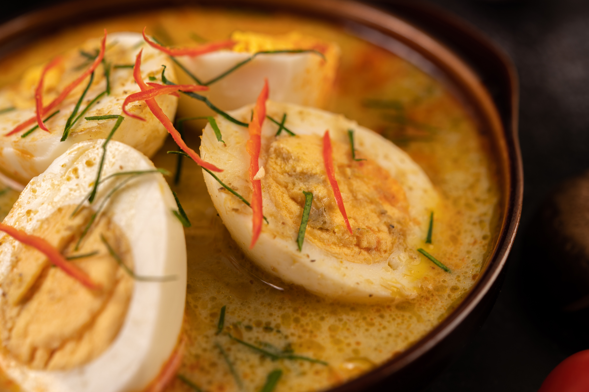 Overhead flat-lay of all ingredients for Aromatic Ethiopian Doro Wat with Spiced Boiled Eggs laid out on a kitchen surface.