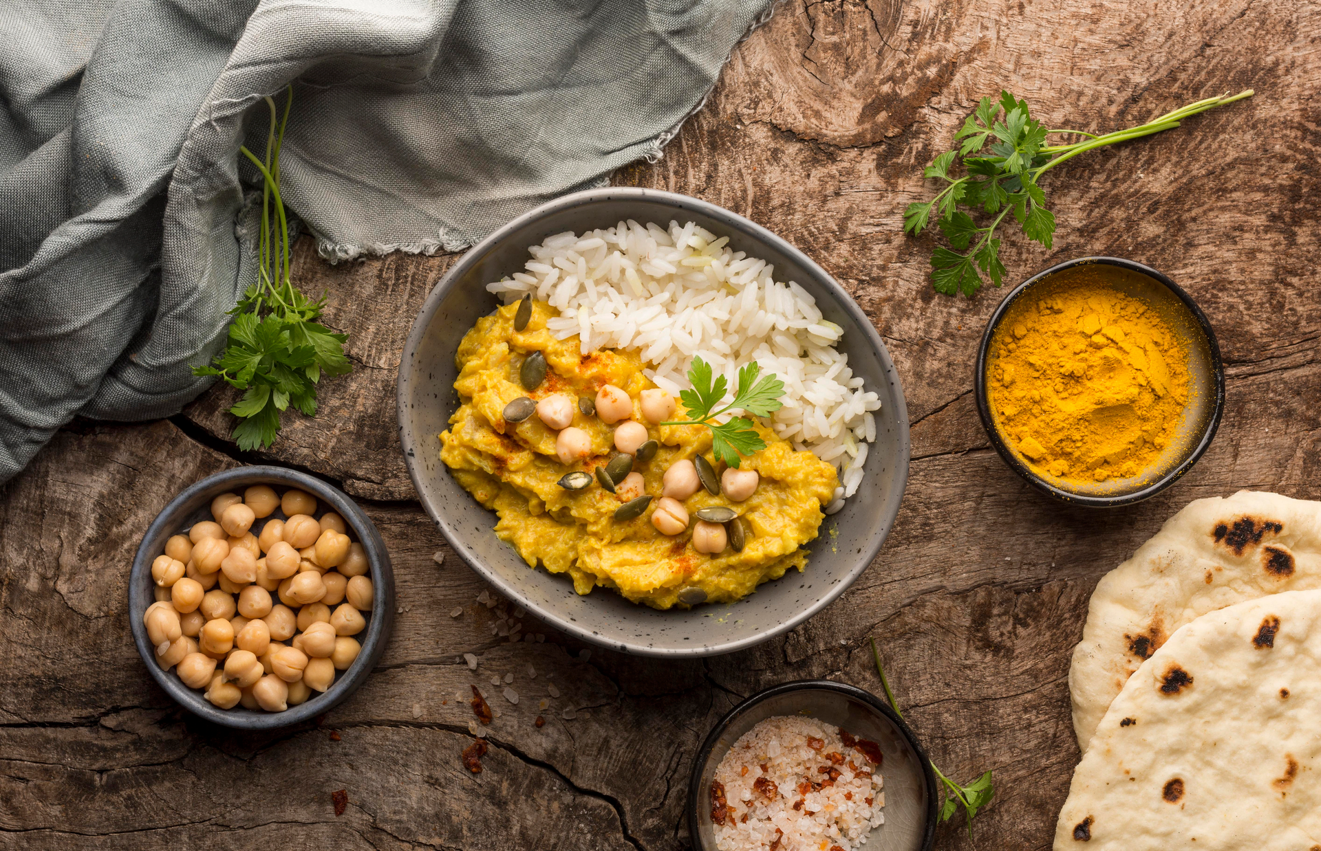 Overhead flat-lay of all ingredients for Aromatic Indian Curry Leaf Rice with Lentils and Mustard Seeds laid out on a kitchen surface.