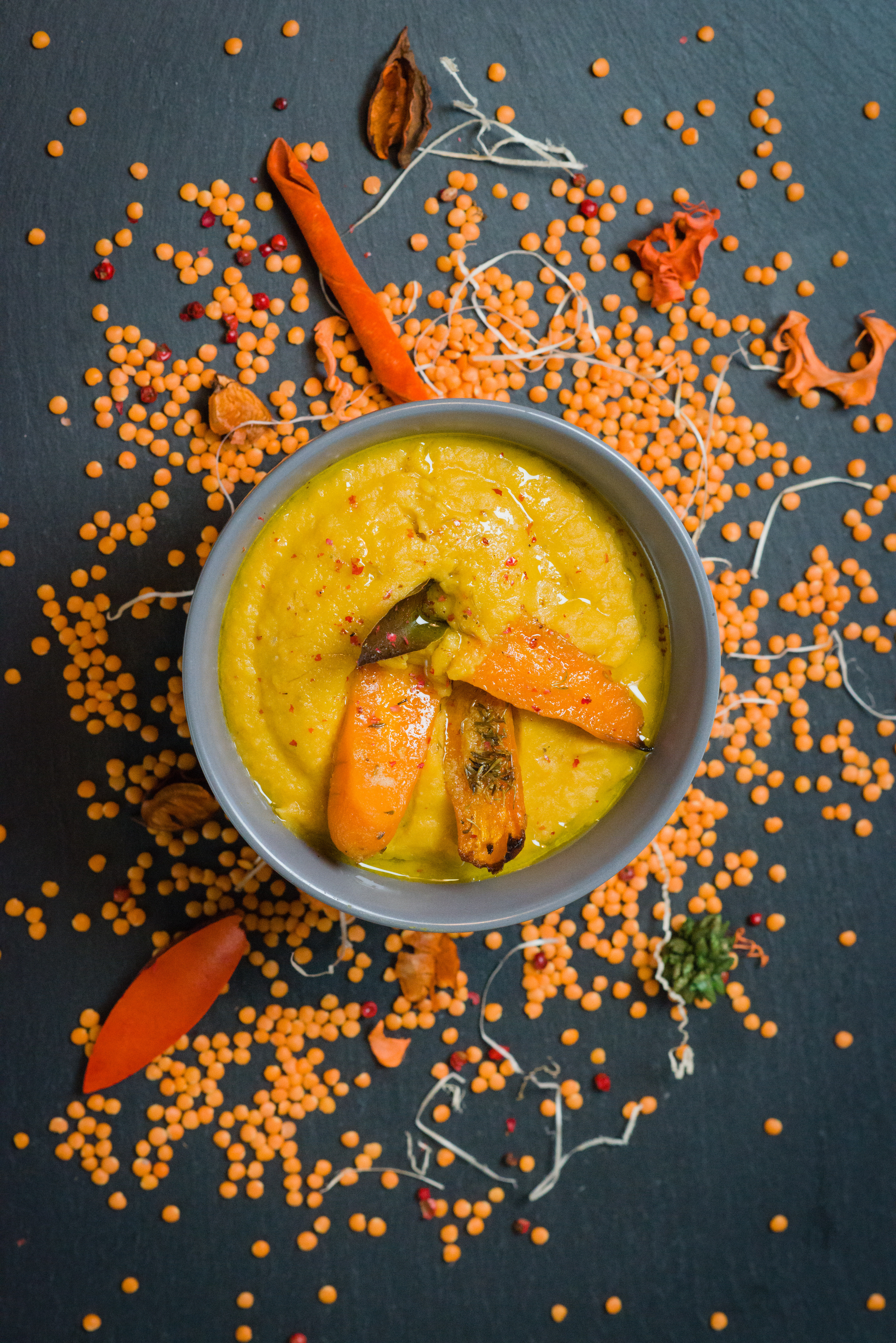 Overhead flat-lay of all ingredients for Aromatic Indian Khichdi with Moong Dal and Spices laid out on a kitchen surface.