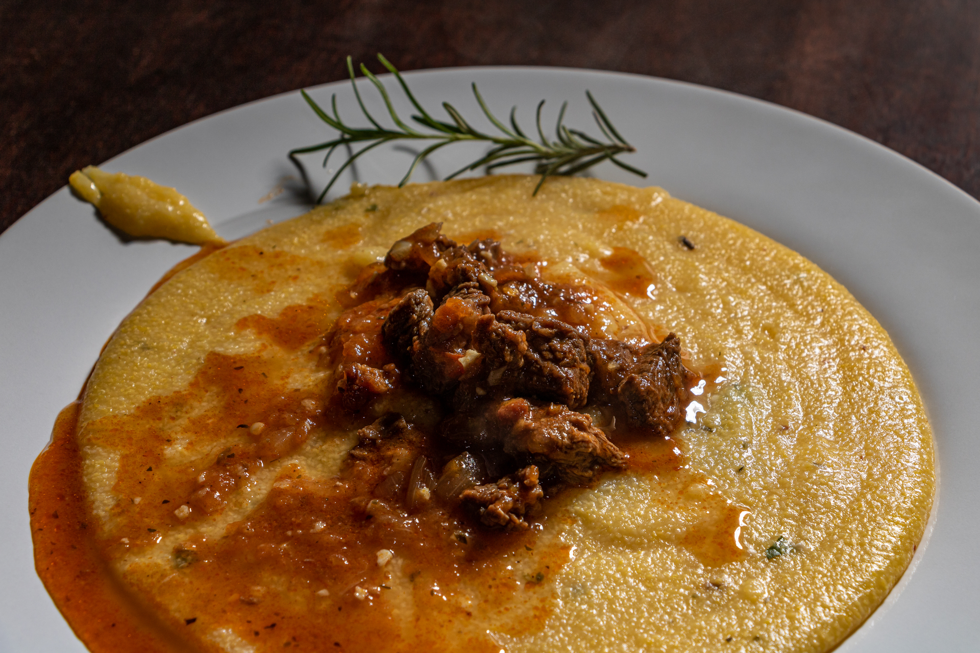 Aromatic Italian Lamb Ragu with Rosemary Polenta — Main Course served and photographed from above