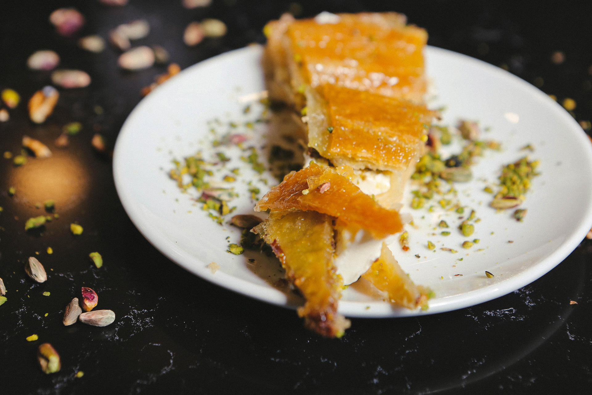 Overhead flat-lay of all ingredients for Aromatic Lebanese Baklava with Saffron Syrup laid out on a kitchen surface.