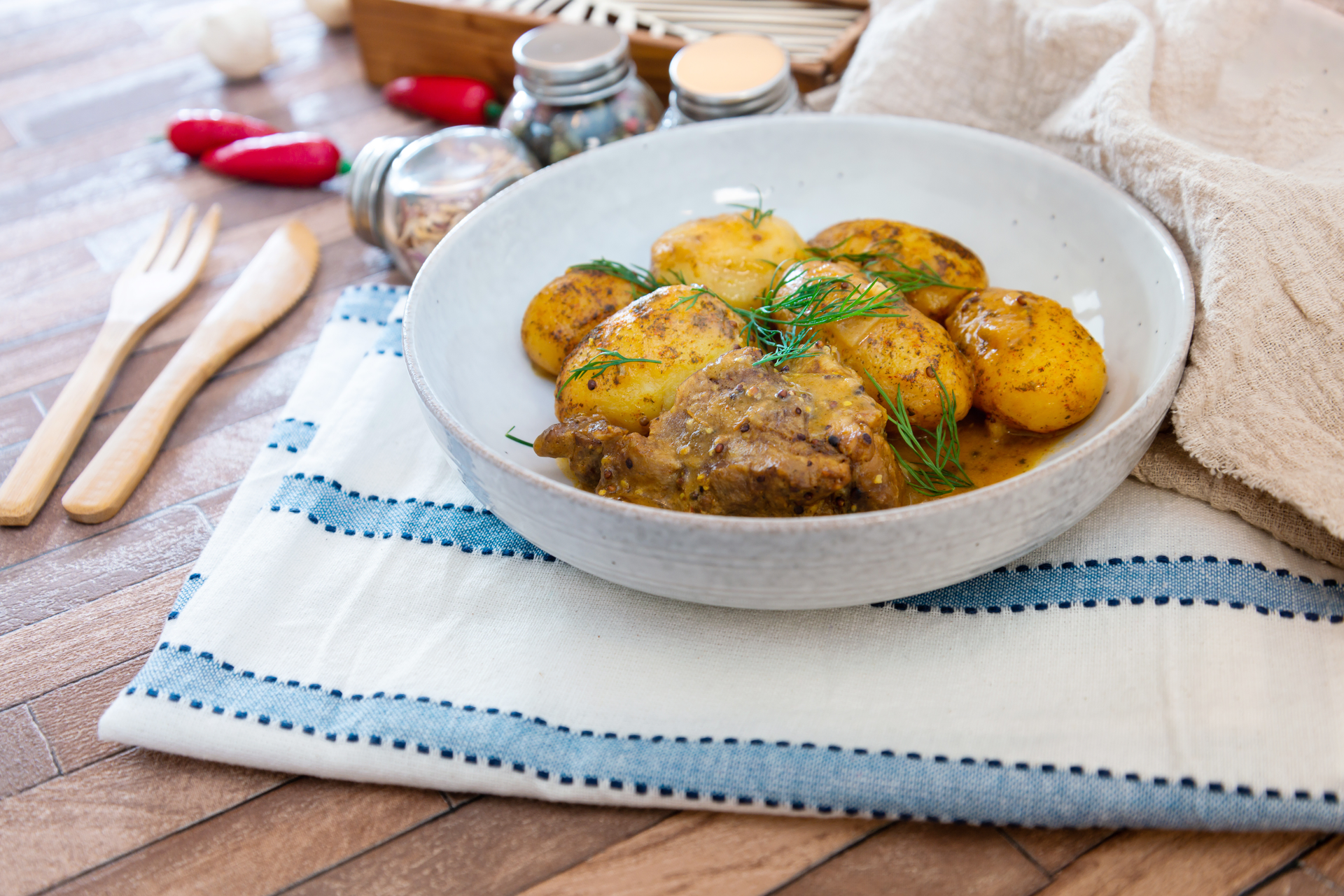 Overhead flat-lay of all ingredients for Aromatic Moldovan Mamaliga with Pork Stew laid out on a kitchen surface.