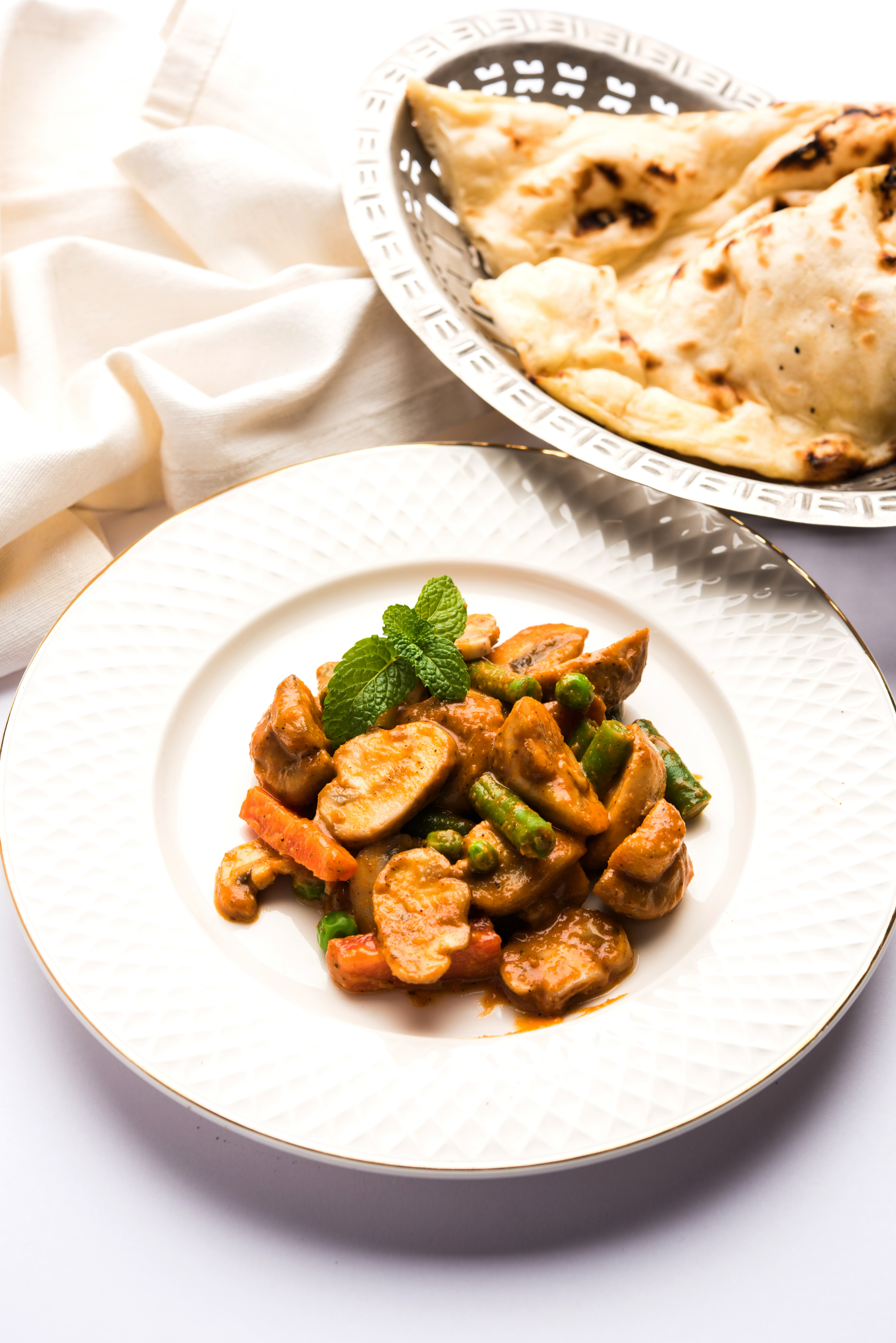 Overhead flat-lay of all ingredients for Aromatic Sri Lankan Kottu Roti with Chicken and Vegetables laid out on a kitchen surface.