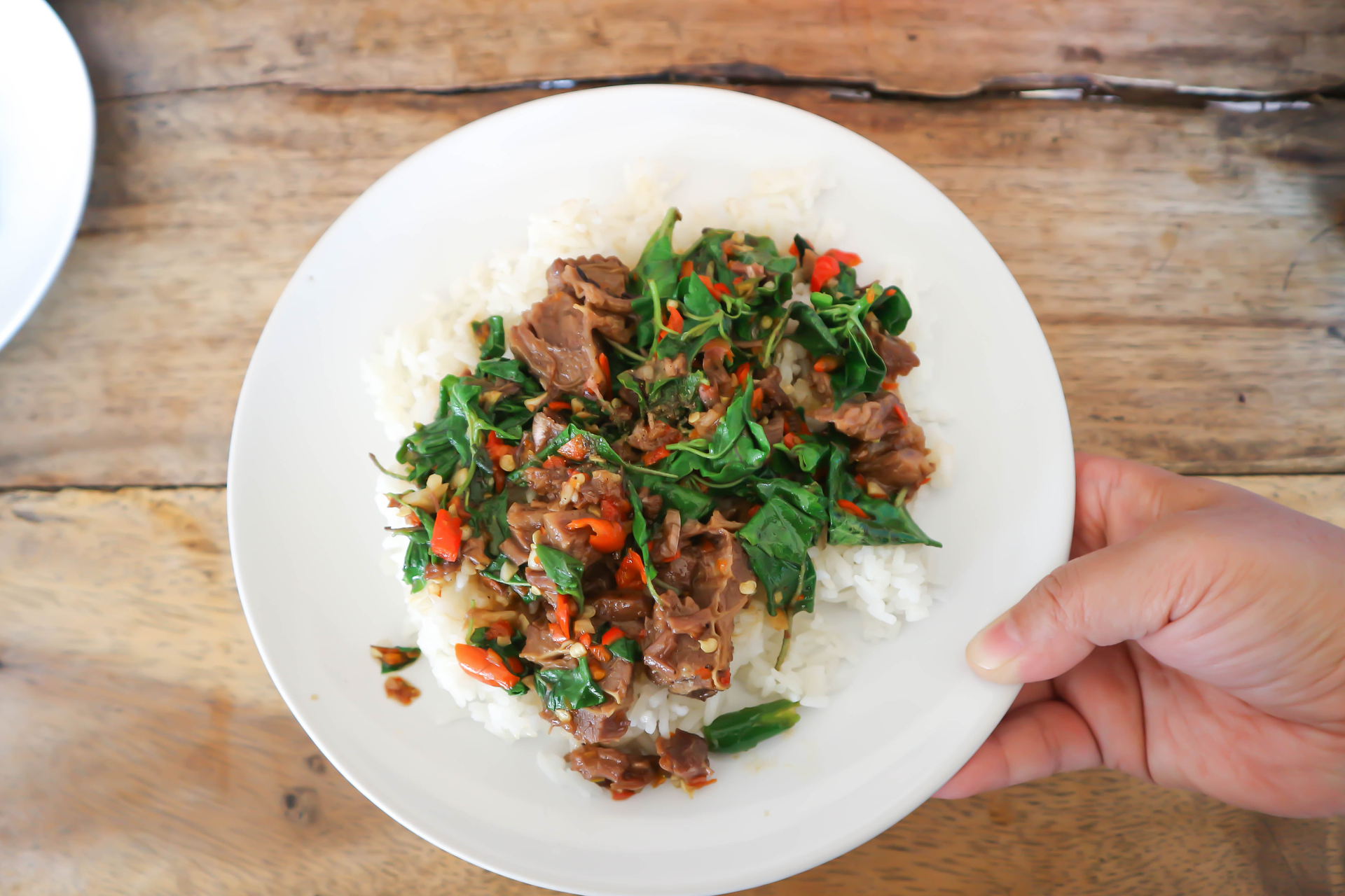 Overhead flat-lay of all ingredients for Aromatic Thai Basil Pork with Jasmine Rice laid out on a kitchen surface.