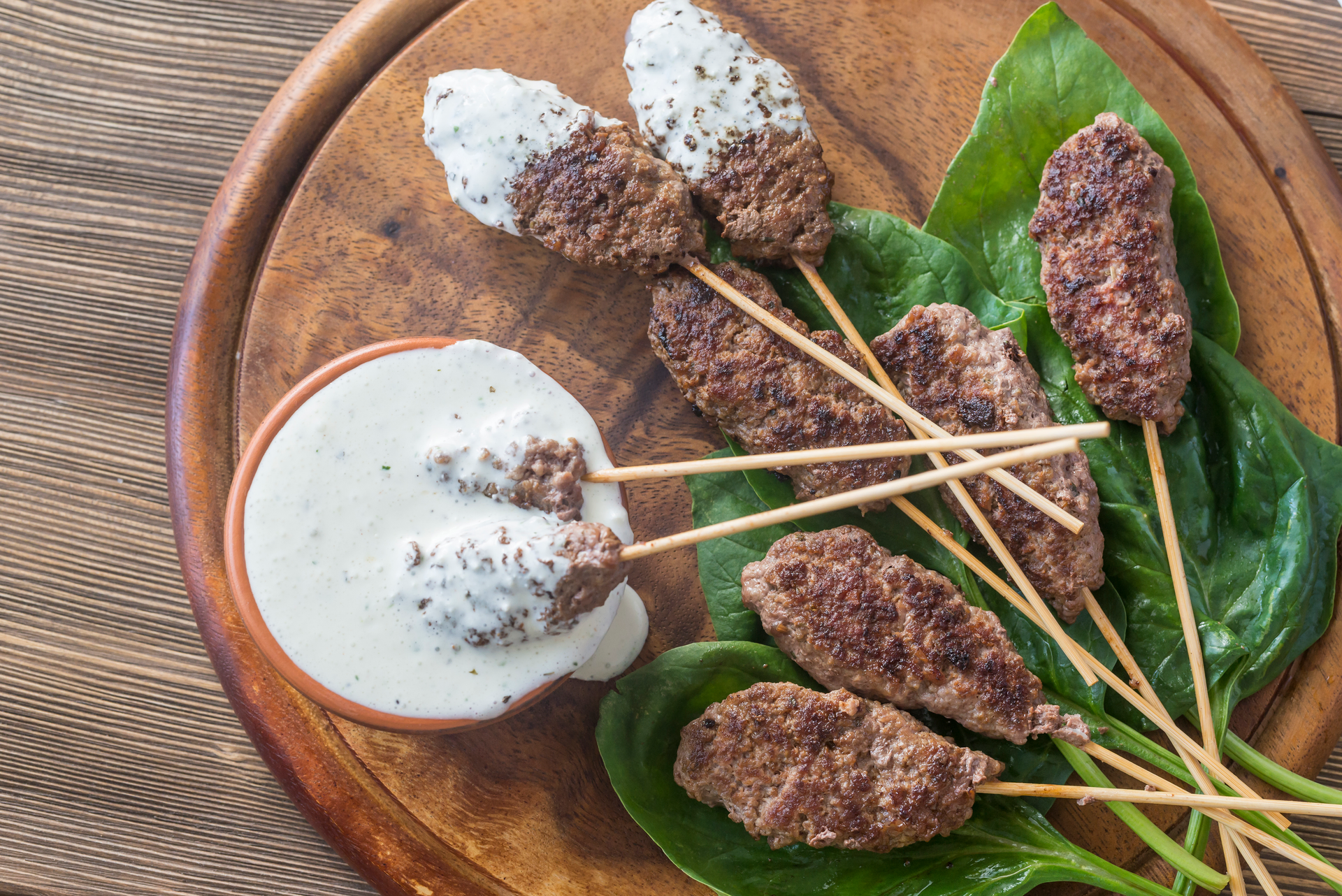 Overhead flat-lay of all ingredients for Aromatic Thai Lemongrass Beef Skewers with Mint Yogurt Sauce laid out on a kitchen surface.