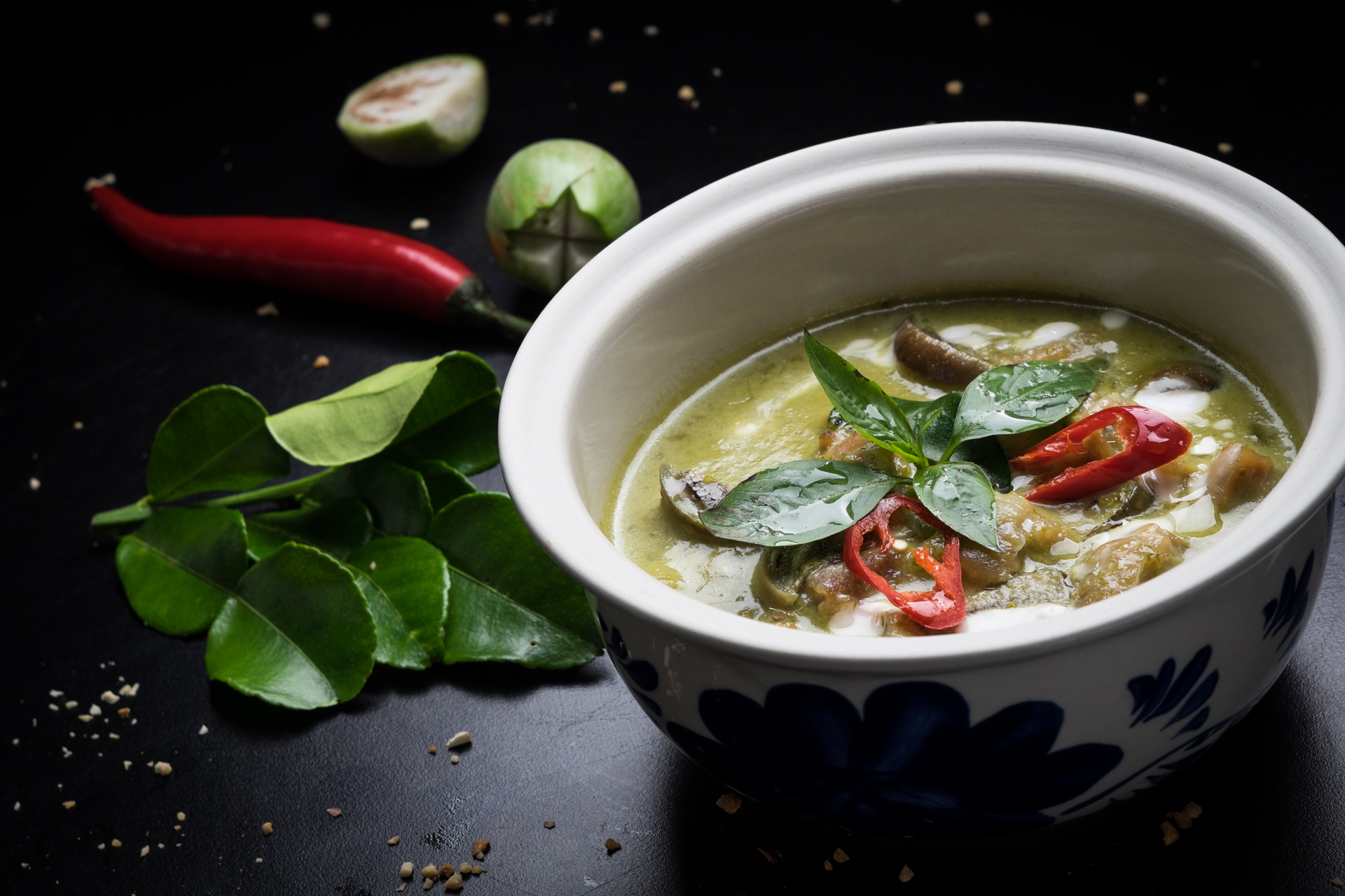 Overhead flat-lay of all ingredients for Aromatic Thai Lemongrass Chicken Soup with Coconut Milk laid out on a kitchen surface.