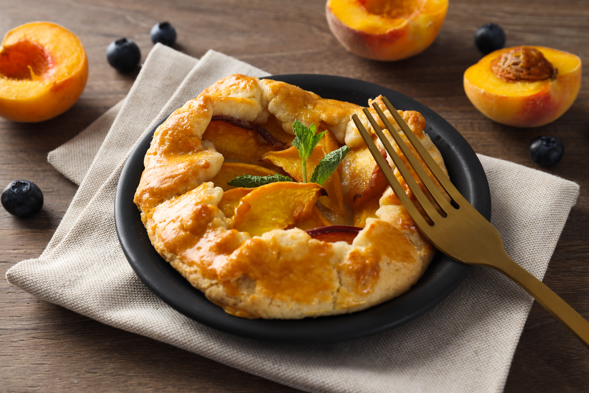 Overhead flat-lay of all ingredients for Artisan Swiss Almond Galette with Apricot Filling laid out on a kitchen surface.