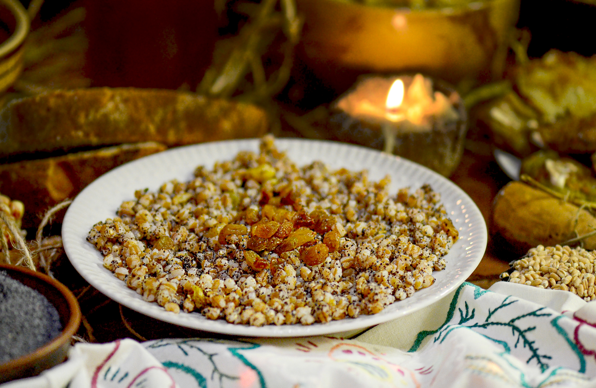 Overhead flat-lay of all ingredients for Astral Moroccan Freekeh Pilaf with Roasted Cauliflower and Almonds laid out on a kitchen surface.
