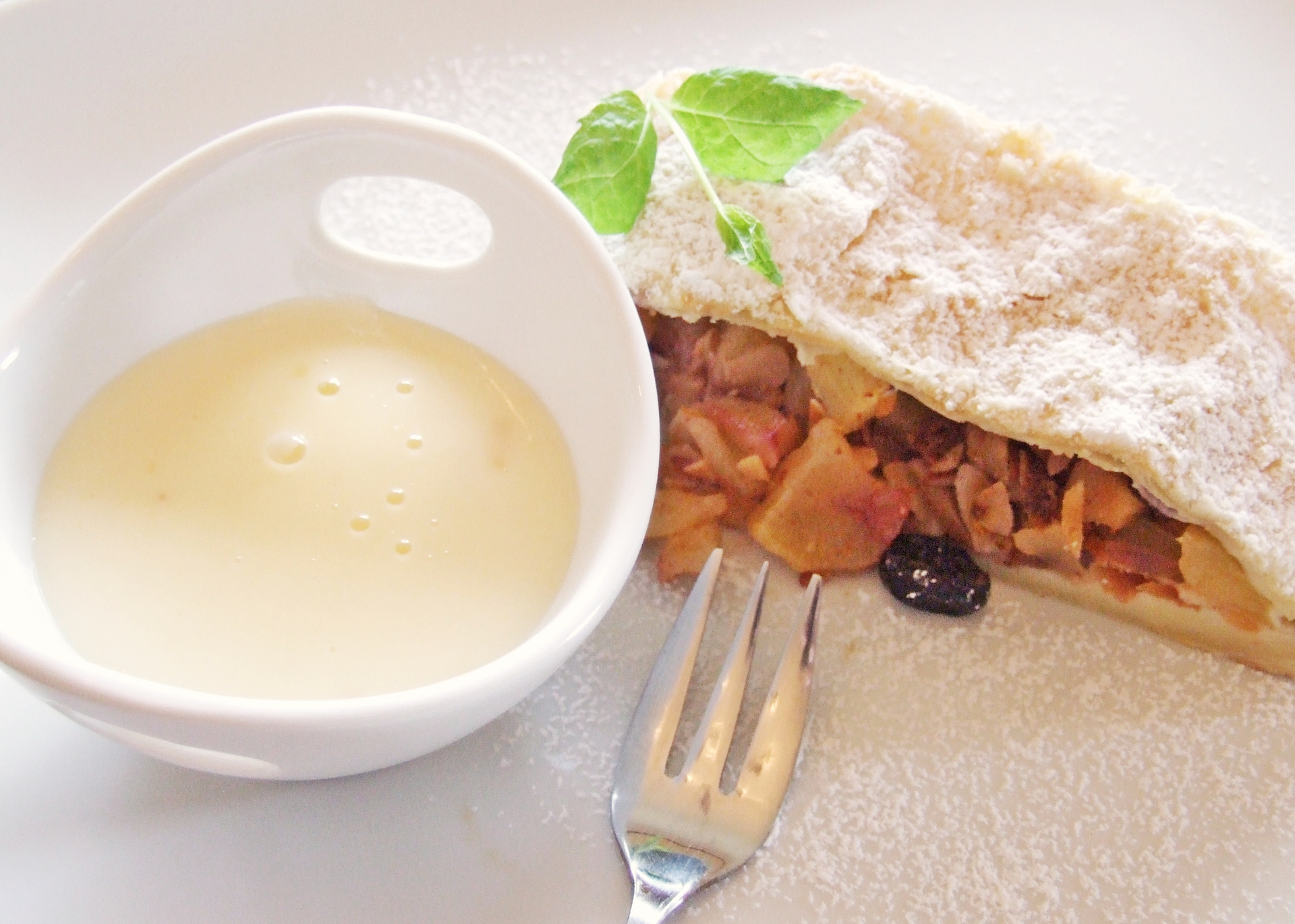 Overhead flat-lay of all ingredients for Austrian Topfenstrudel with Vanilla Sauce laid out on a kitchen surface.
