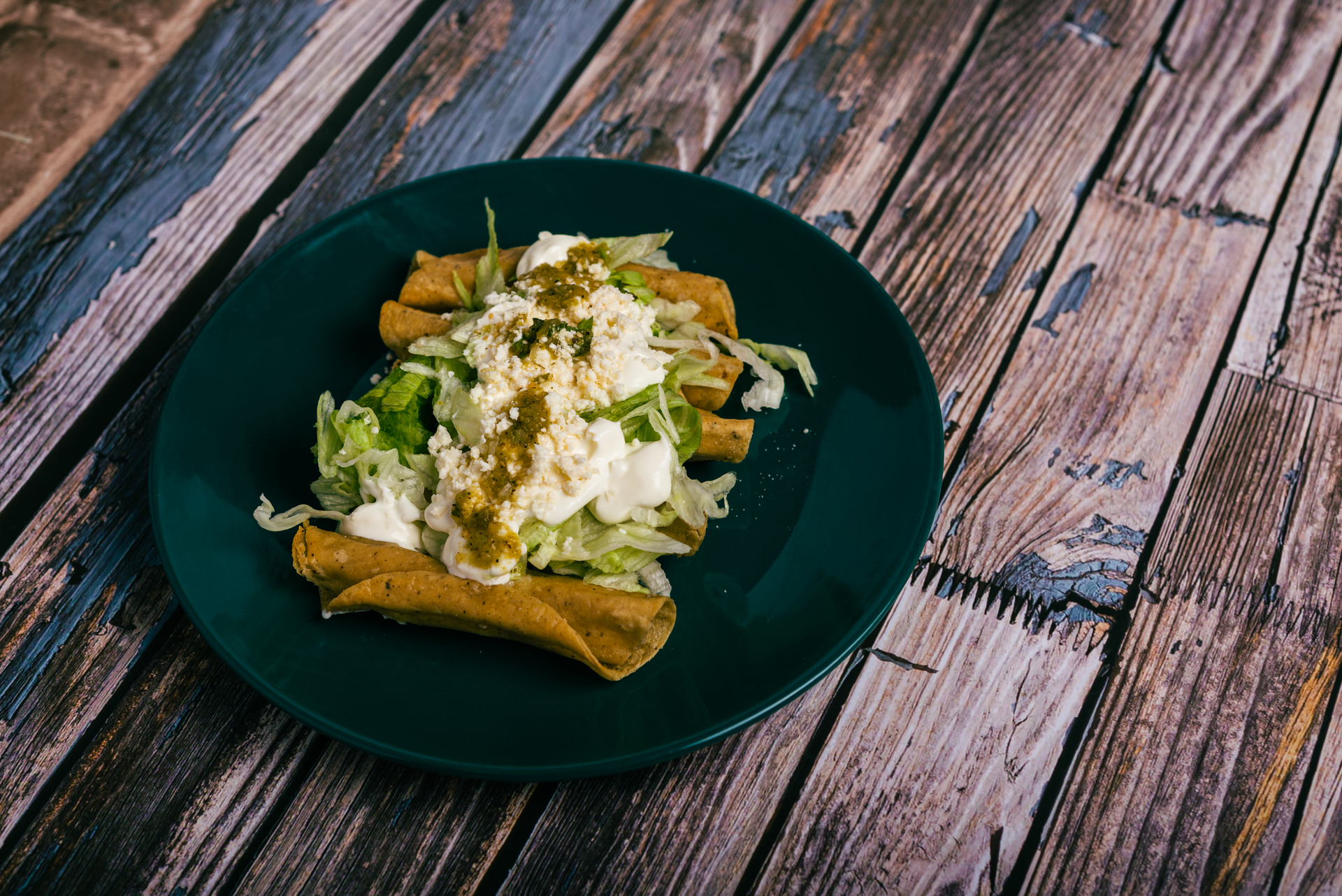 Overhead flat-lay of all ingredients for Authentic Mexican Enchiladas Verdes laid out on a kitchen surface.
