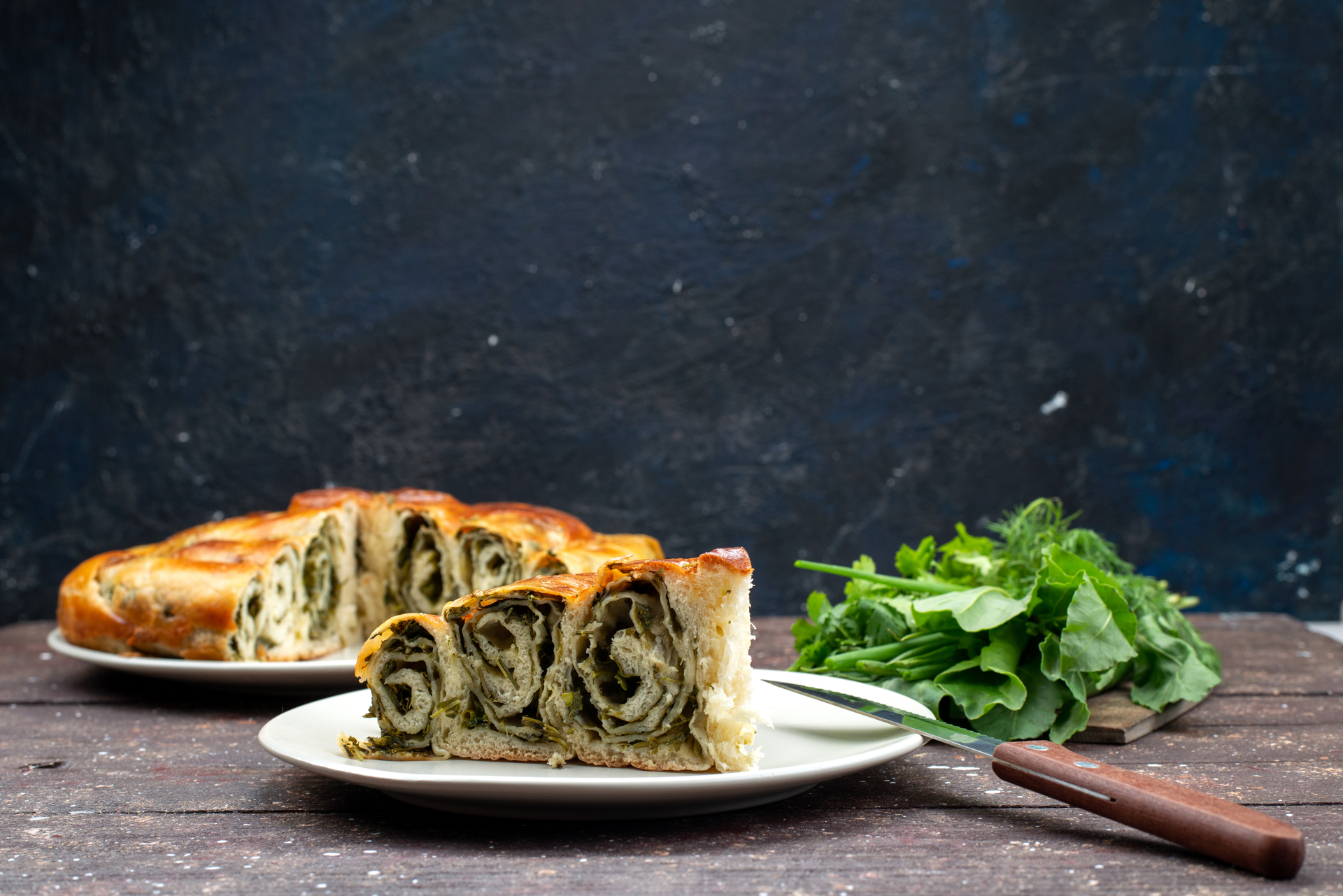 Overhead flat-lay of all ingredients for Balkan Burek with Savory Spinach and Feta Filling laid out on a kitchen surface.