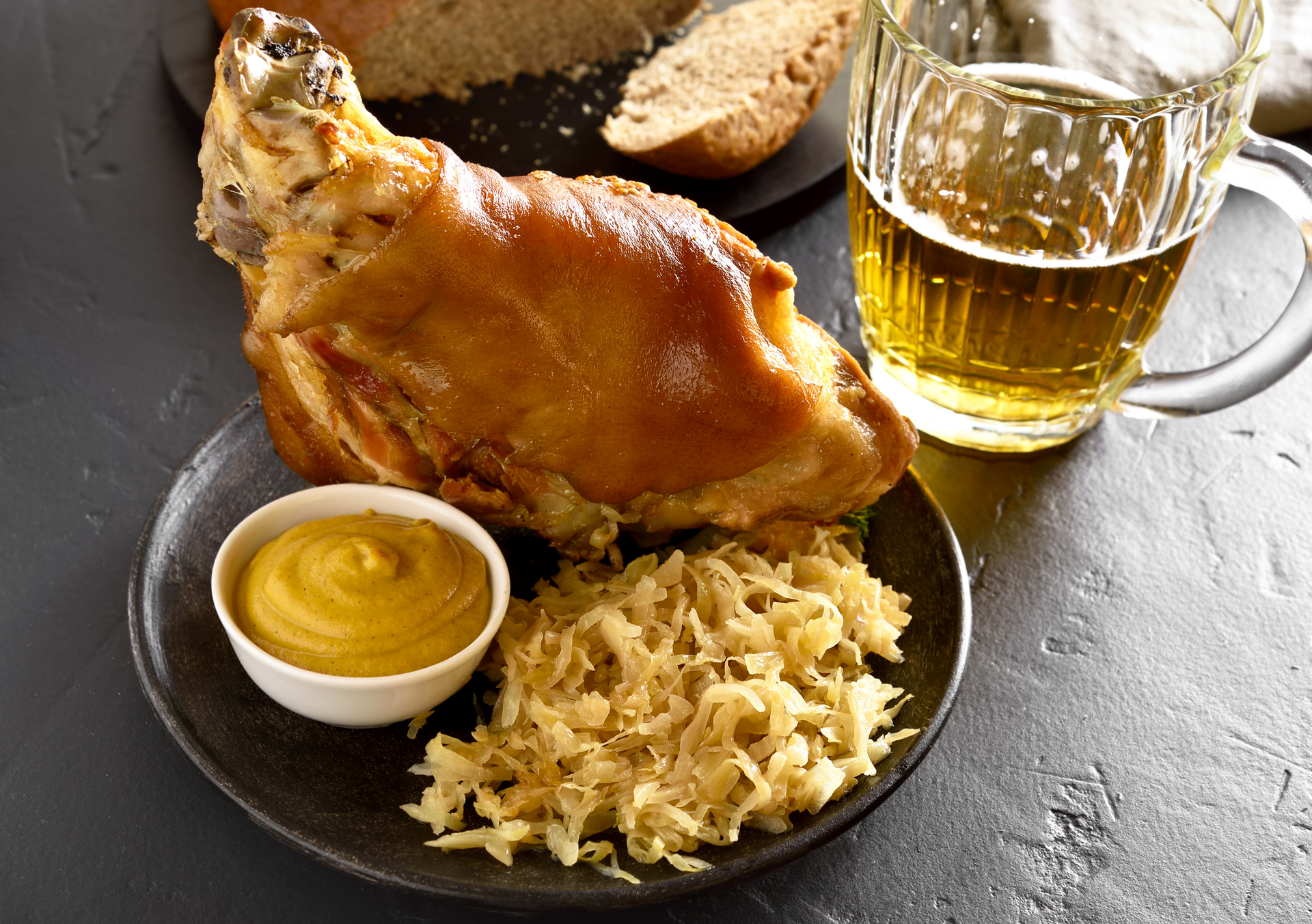 Bavarian Schweinshaxe with Sauerkraut and Potato Dumplings — Main Course served and photographed from above