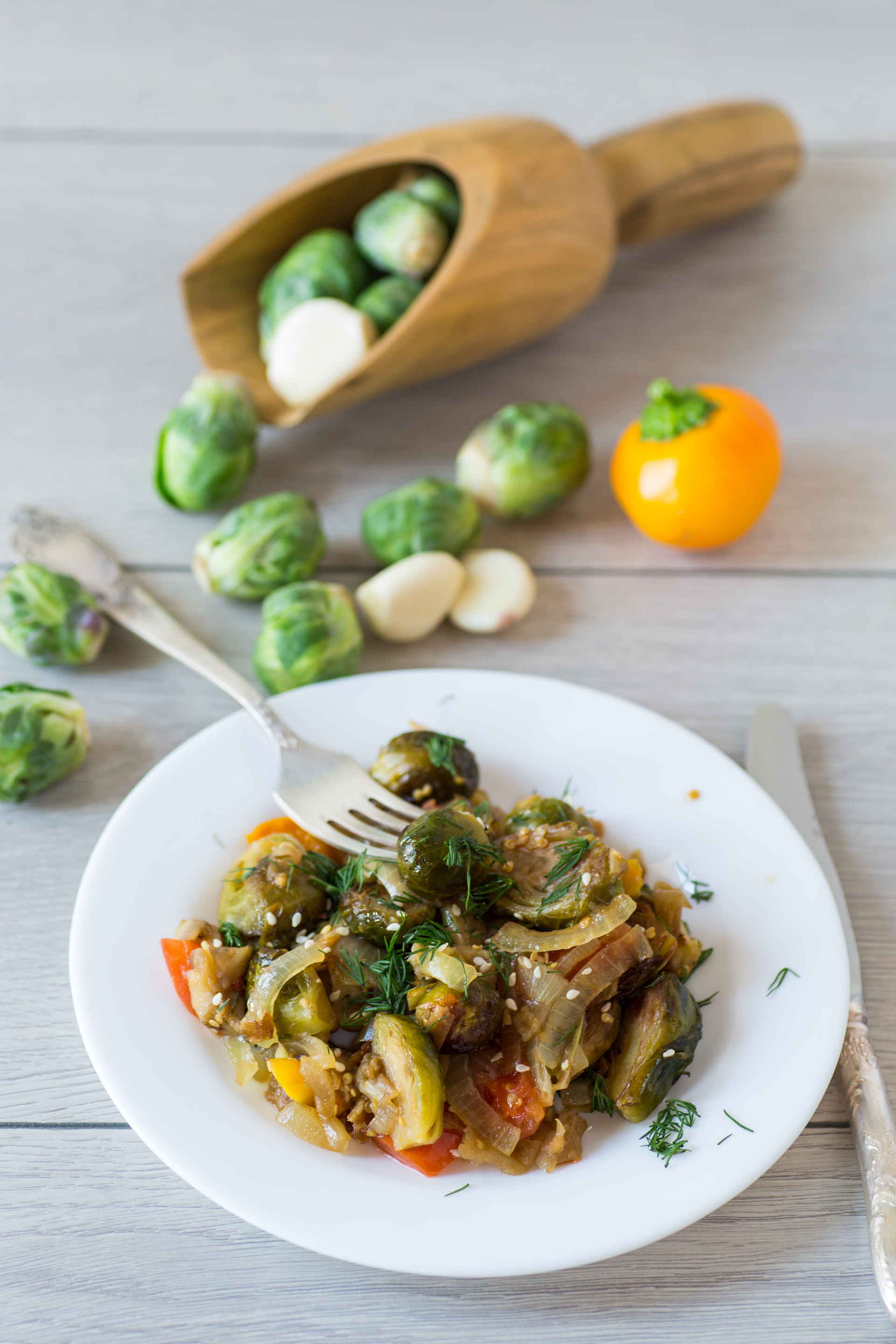 Overhead flat-lay of all ingredients for Belgian Stoemp with Caramelized Brussels Sprouts laid out on a kitchen surface.