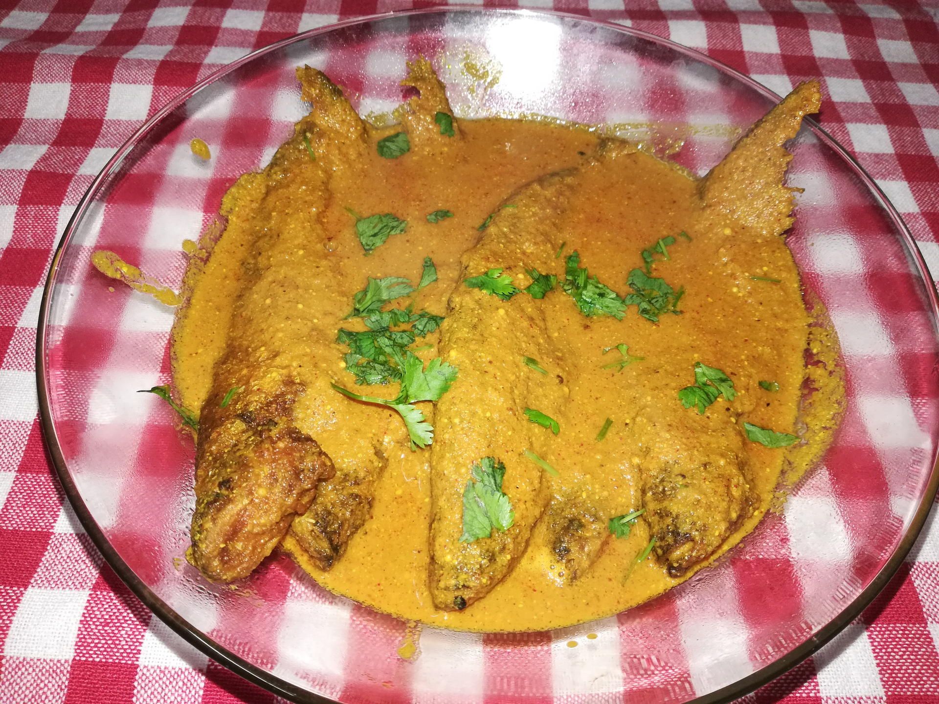 Overhead flat-lay of all ingredients for Bengali Shorshe Ilish laid out on a kitchen surface.
