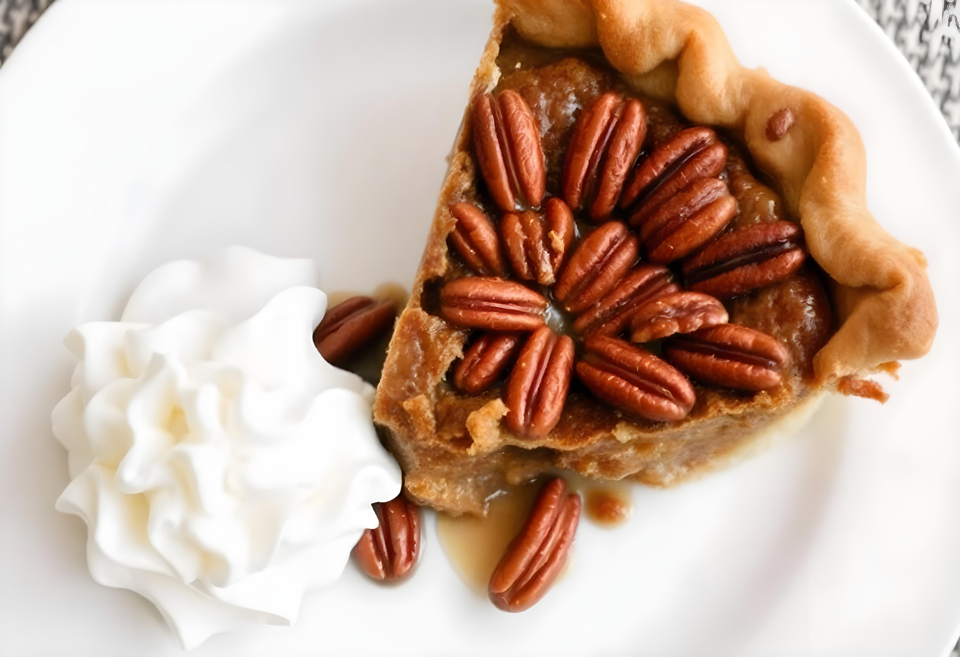 Overhead flat-lay of all ingredients for Bourbon-Infused Southern Pecan Pie with Maple Whipped Cream laid out on a kitchen surface.