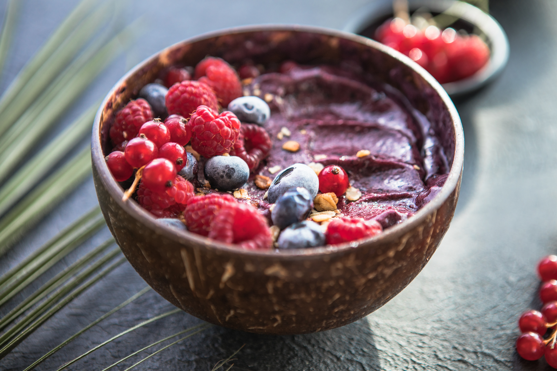 Overhead flat-lay of all ingredients for Brazilian Açaí Bowl with Granola and Fresh Fruit laid out on a kitchen surface.