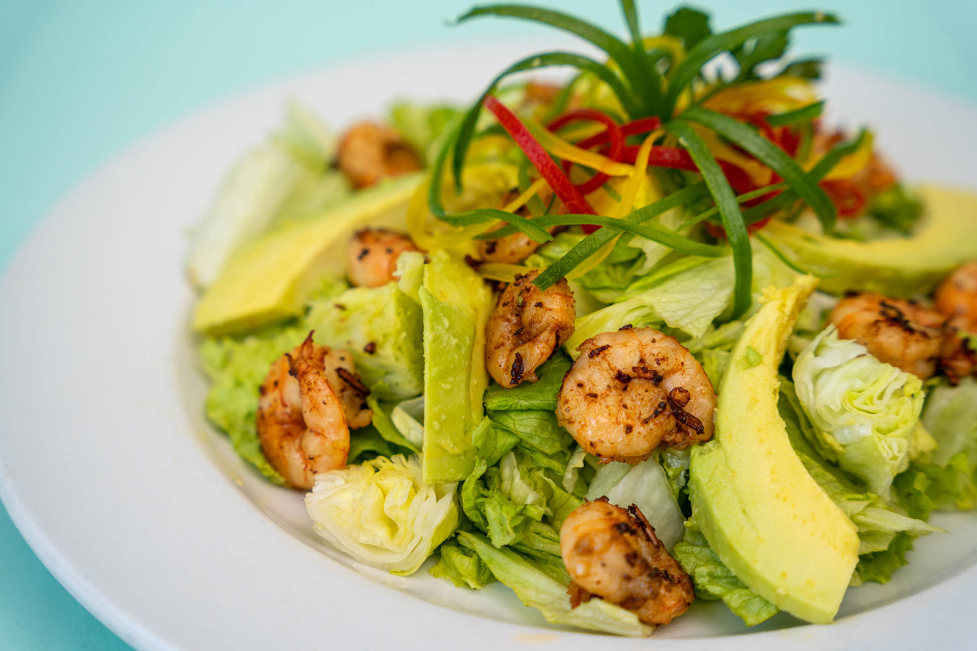Overhead flat-lay of all ingredients for Brazilian Avocado and Shrimp Ceviche with Citrus Dressing laid out on a kitchen surface.