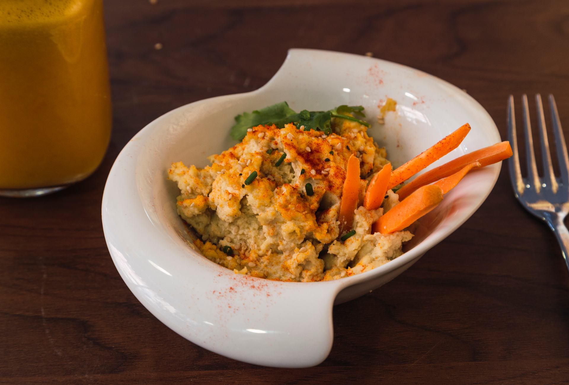 Overhead flat-lay of all ingredients for Brazilian Moqueca Capixaba with Cashew Milk laid out on a kitchen surface.
