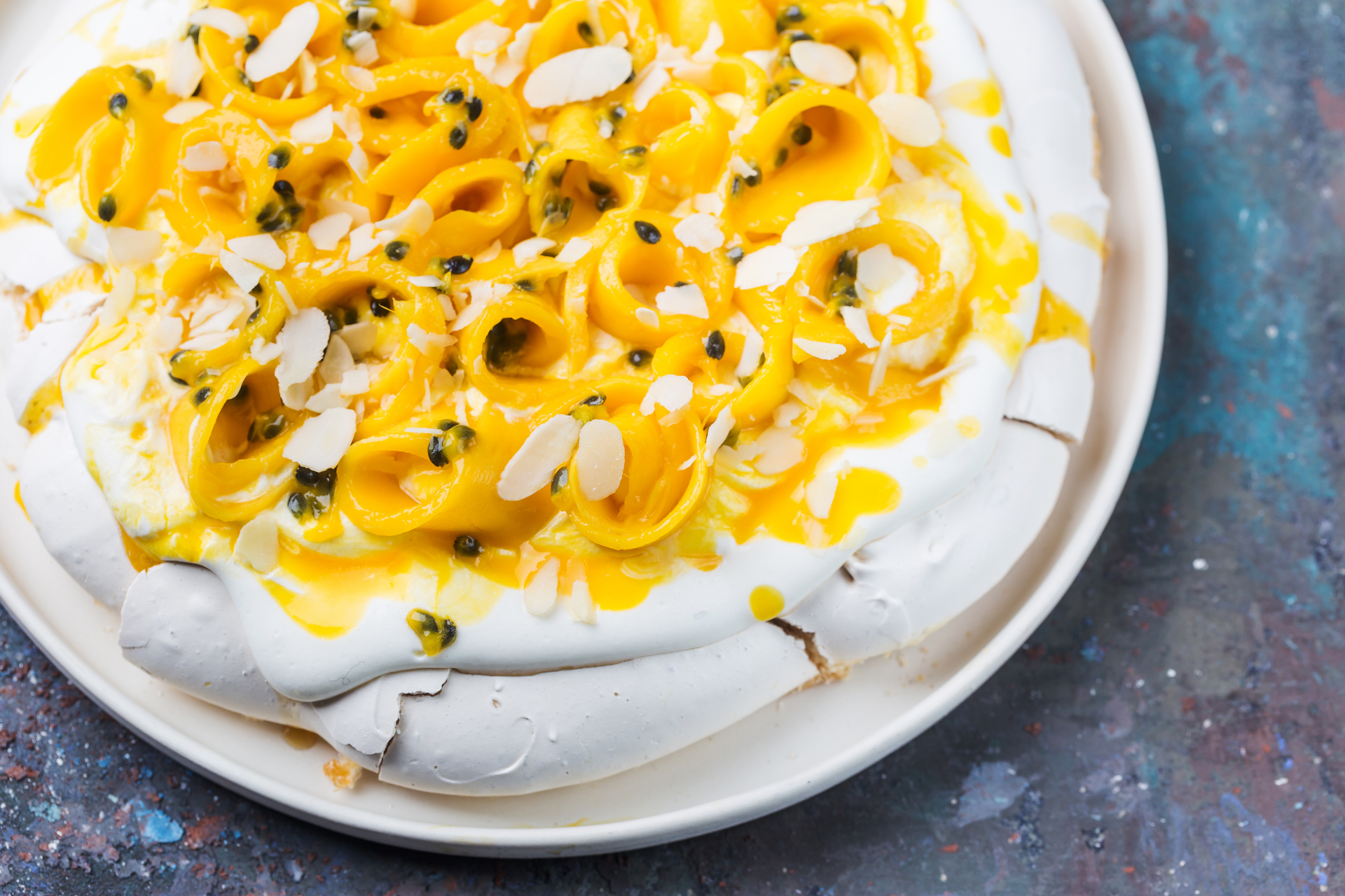 Overhead flat-lay of all ingredients for Brazilian Passion Fruit Mousse with Cashew Crumble laid out on a kitchen surface.