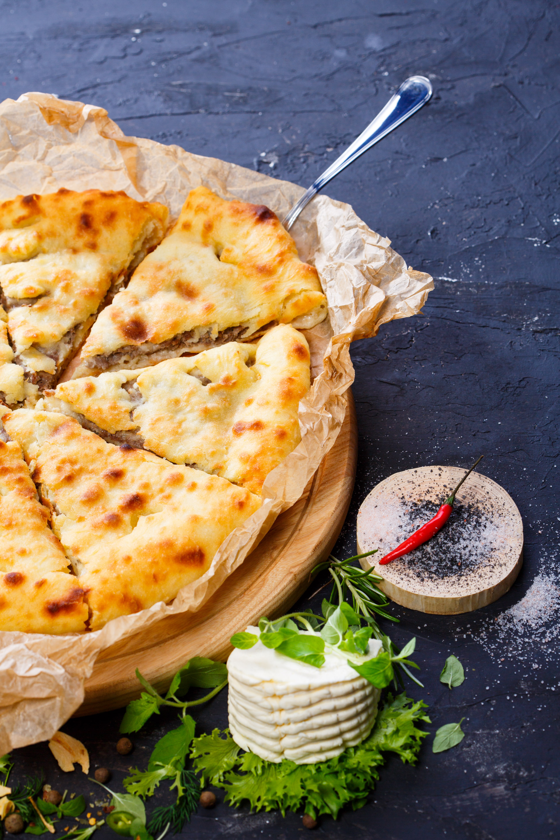 Overhead flat-lay of all ingredients for Bulgarian Banitsa with Leeks and Cheese laid out on a kitchen surface.