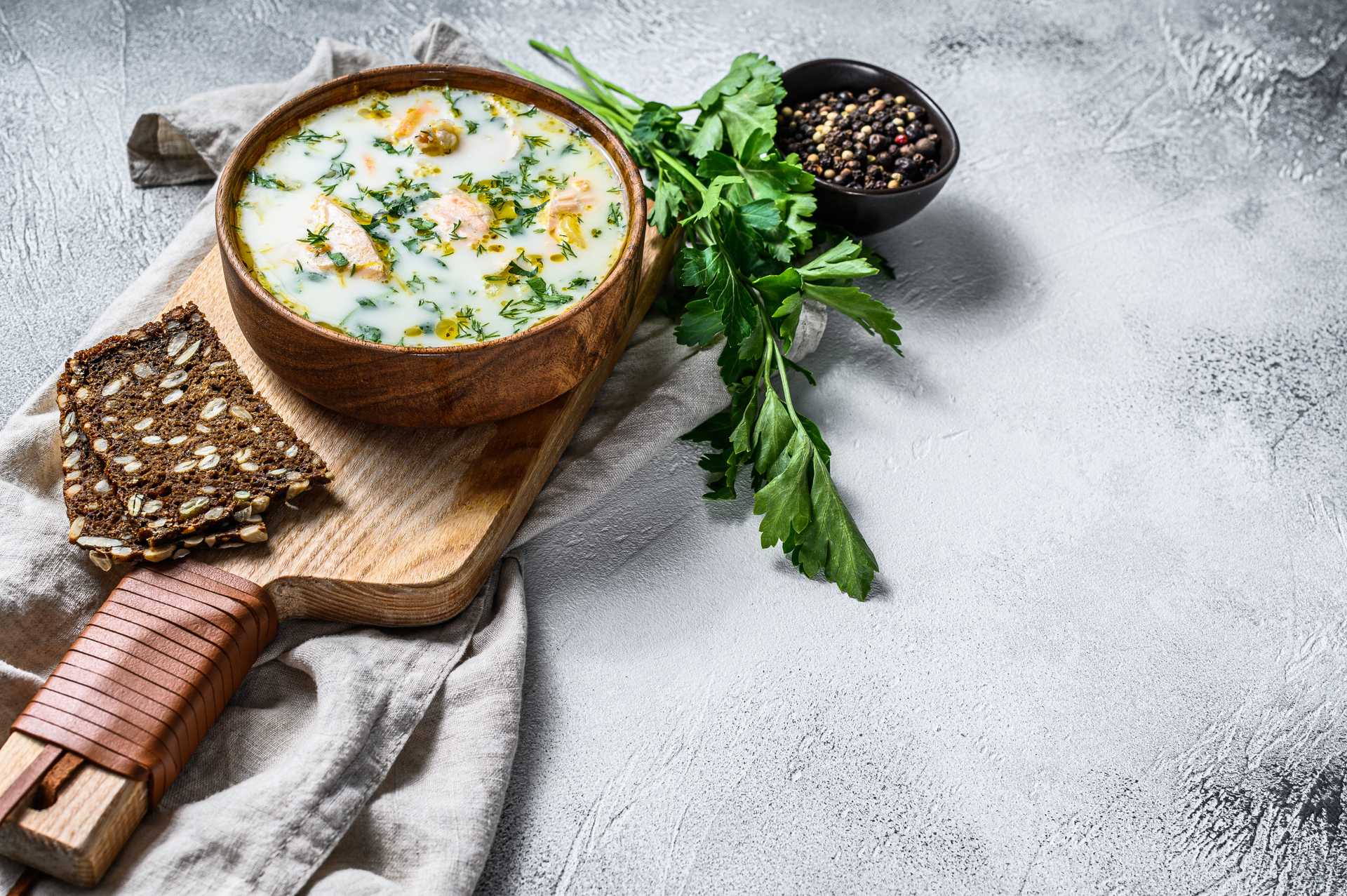 Overhead flat-lay of all ingredients for Bulgarian Tarator Soup with Dill and Toasted Walnuts laid out on a kitchen surface.