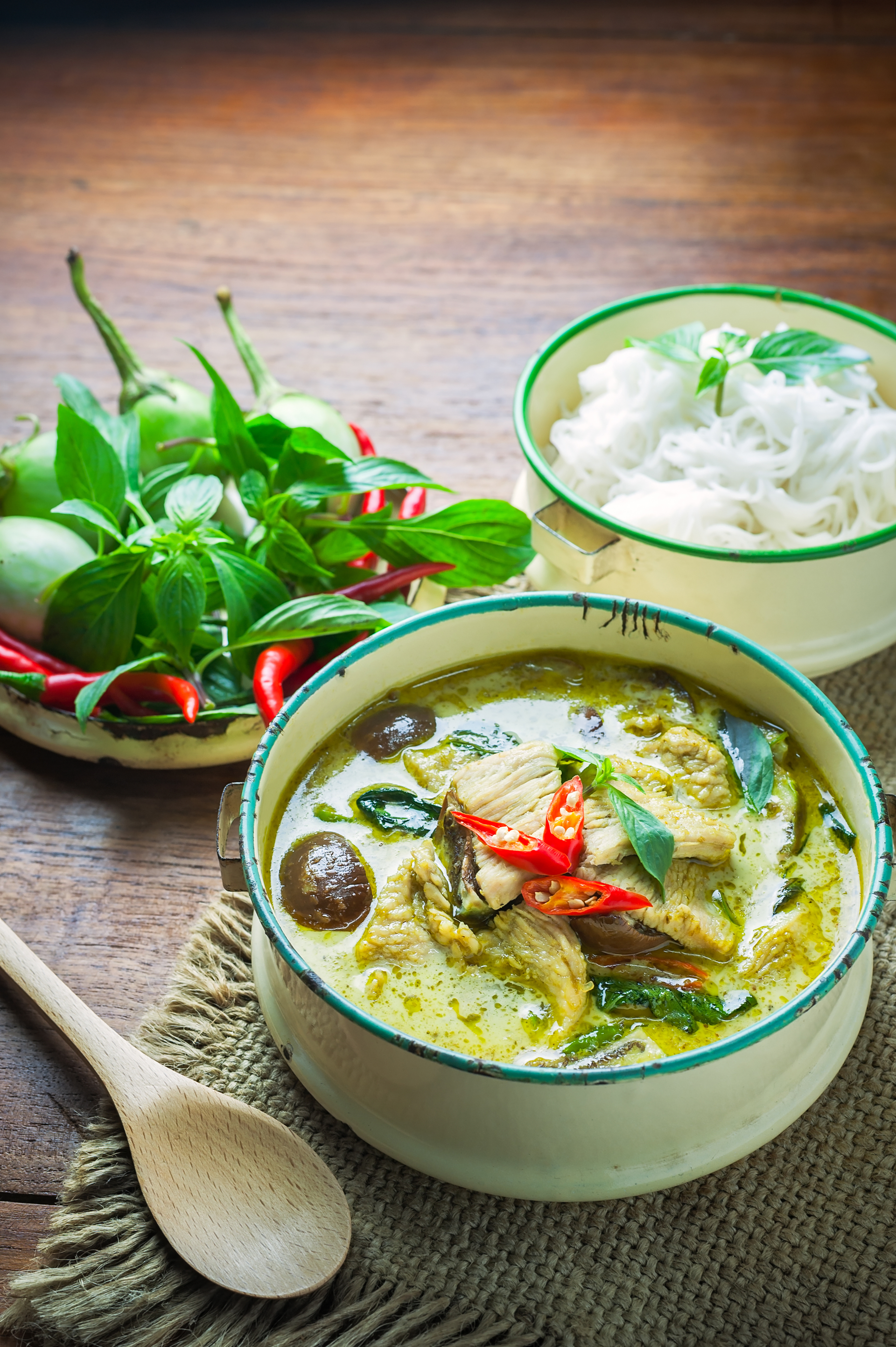 Overhead flat-lay of all ingredients for Burmese Lime Leaf Fish Curry with Coconut Milk laid out on a kitchen surface.