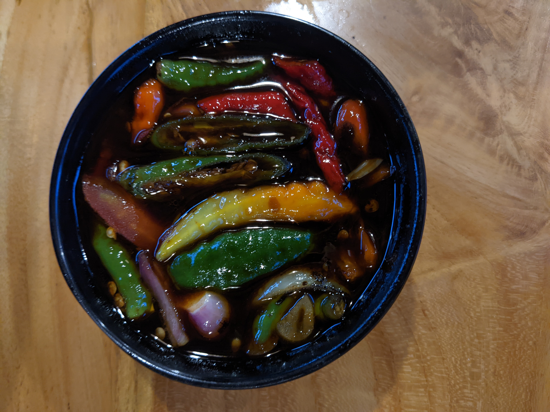 Overhead flat-lay of all ingredients for Burmese Tamarind-Glazed Eggplant with Green Onion Garnish laid out on a kitchen surface.