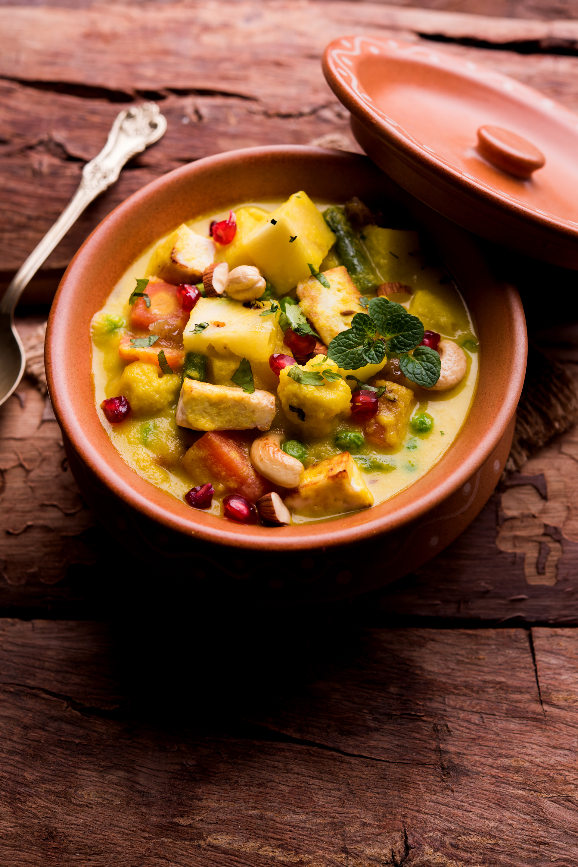 Overhead flat-lay of all ingredients for Burmese Tofu Curry with Tamarind and Turmeric laid out on a kitchen surface.