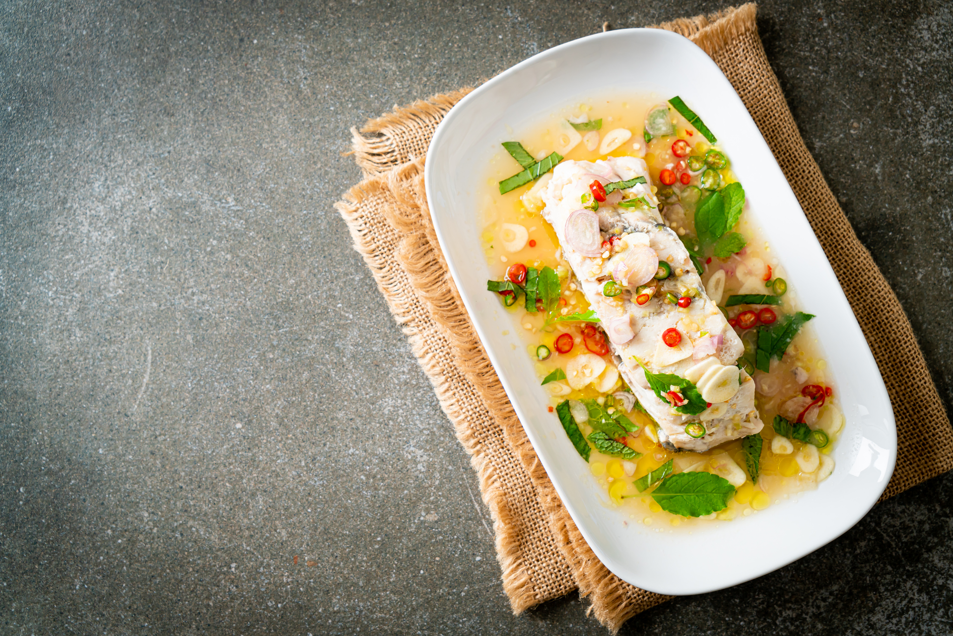 Overhead flat-lay of all ingredients for Caribbean Callaloo with Salted Cod and Coconut Milk laid out on a kitchen surface.