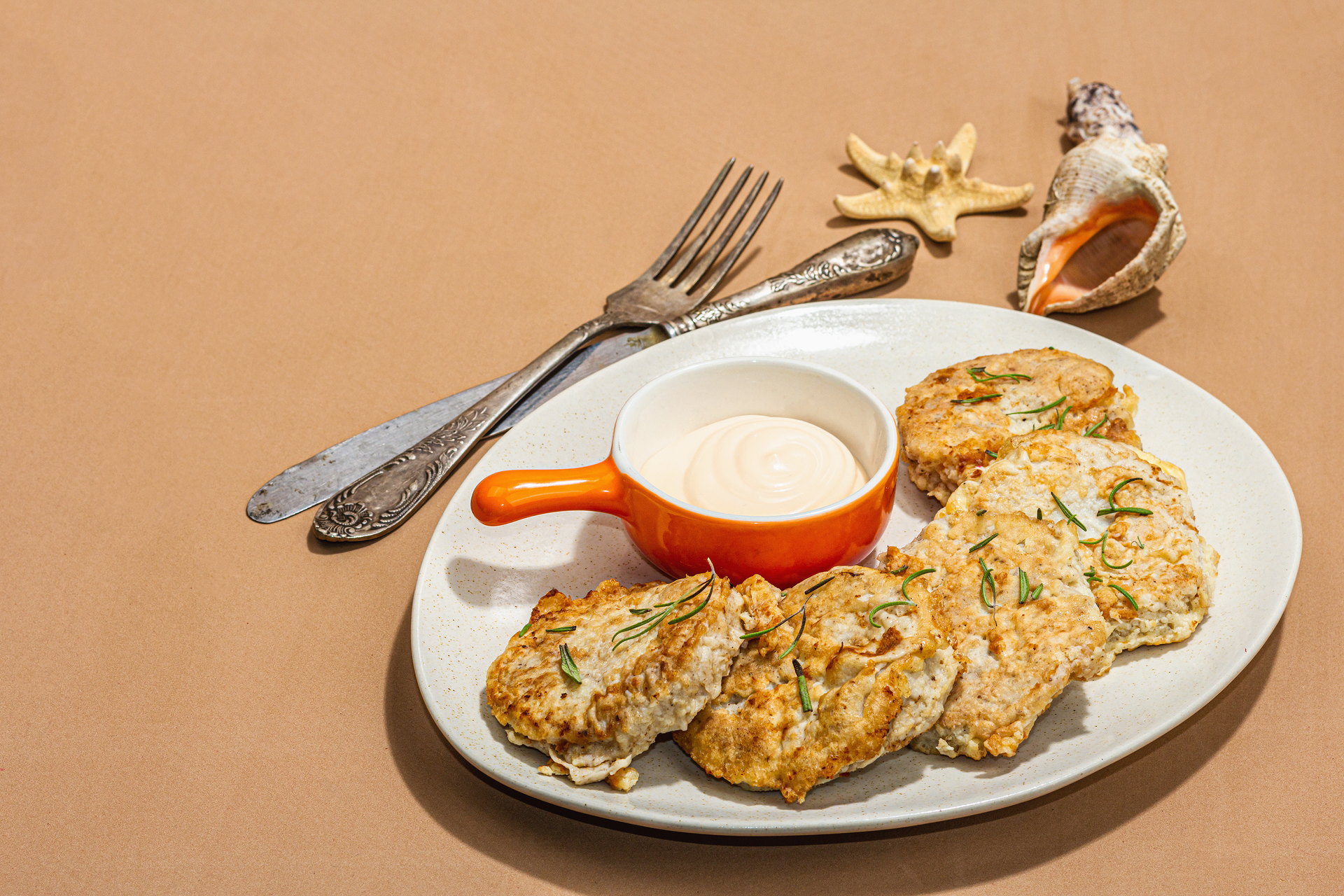 Overhead flat-lay of all ingredients for Caribbean Coconut Cod Fritters with Lime Aioli laid out on a kitchen surface.