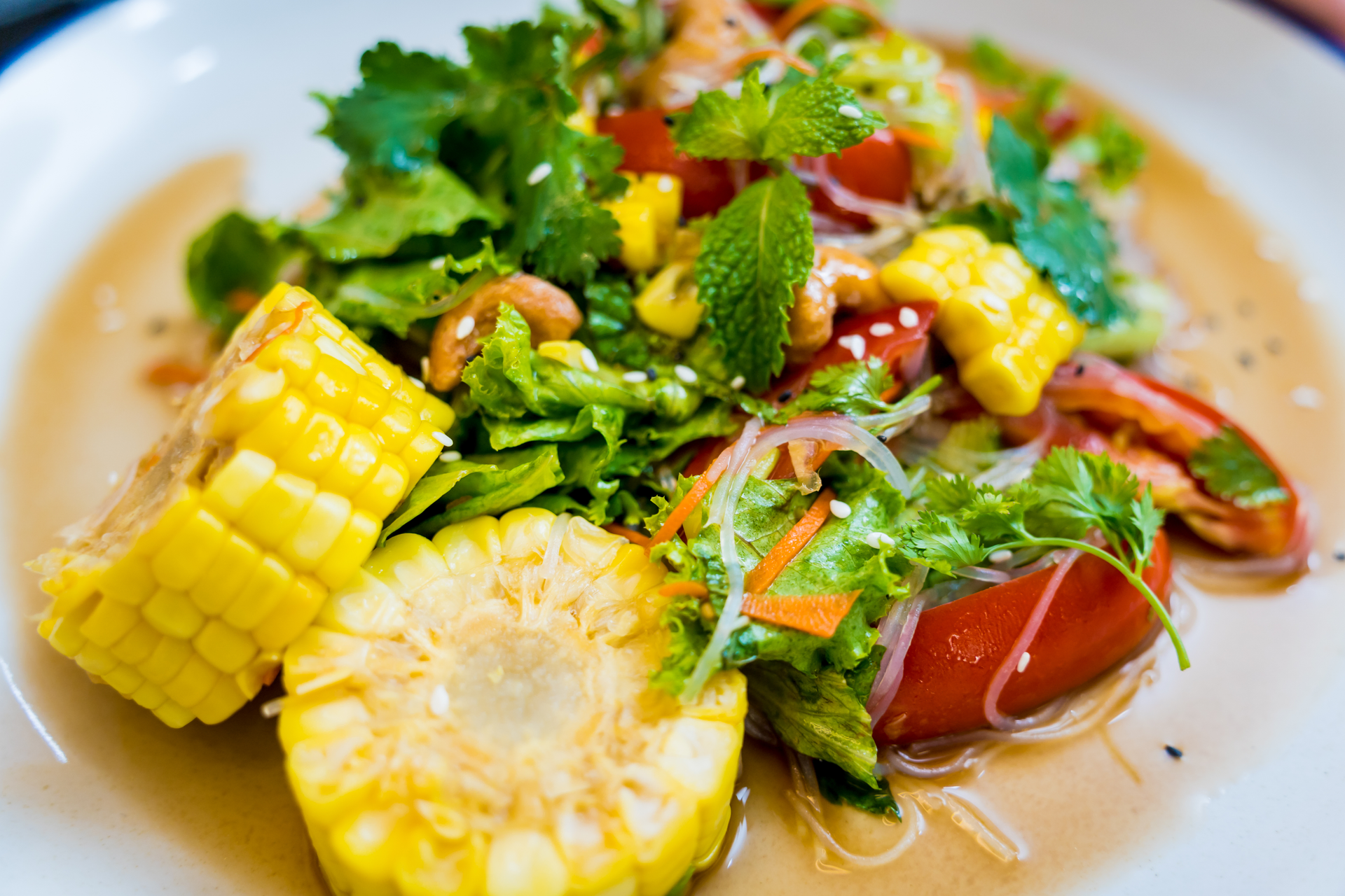 Overhead flat-lay of all ingredients for Caribbean Mango Coconut Jerk Chicken Salad with Lime Vinaigrette laid out on a kitchen surface.