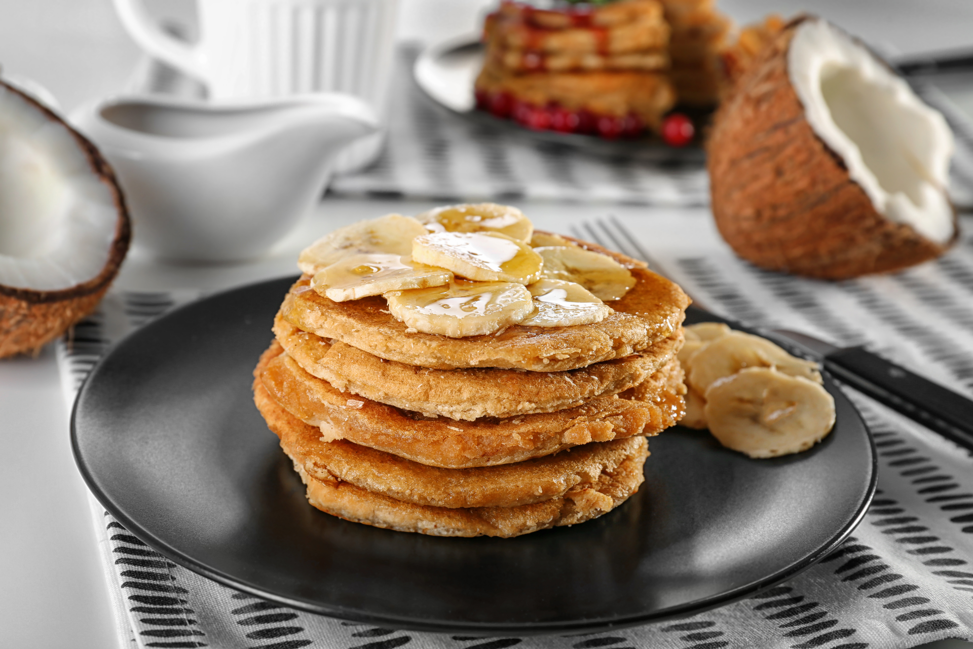 Overhead flat-lay of all ingredients for Caribbean Rum-Infused Plantain Pancakes with Coconut Whip laid out on a kitchen surface.