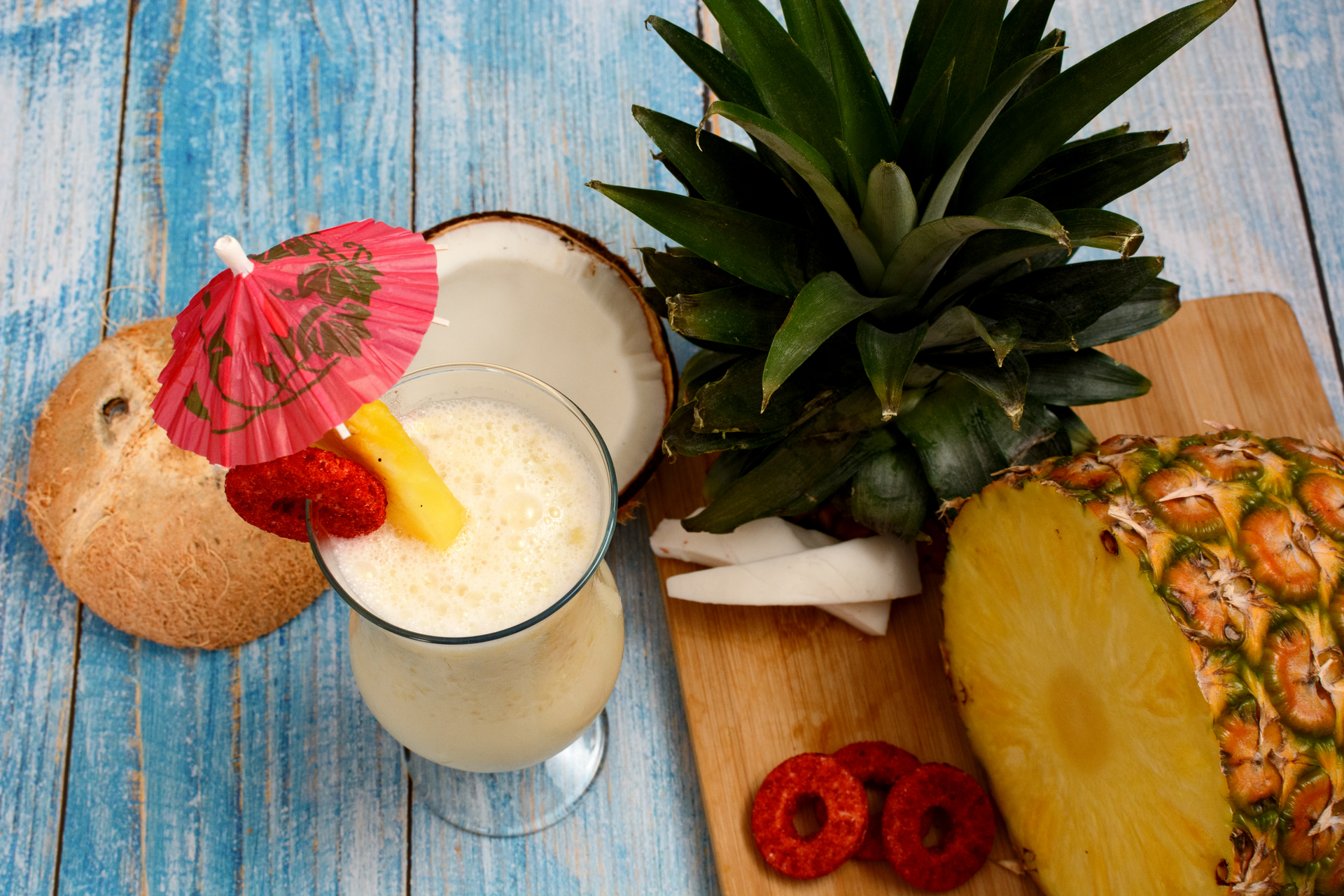 Overhead flat-lay of all ingredients for Caribbean Rum Punch with Guava and Pineapple laid out on a kitchen surface.