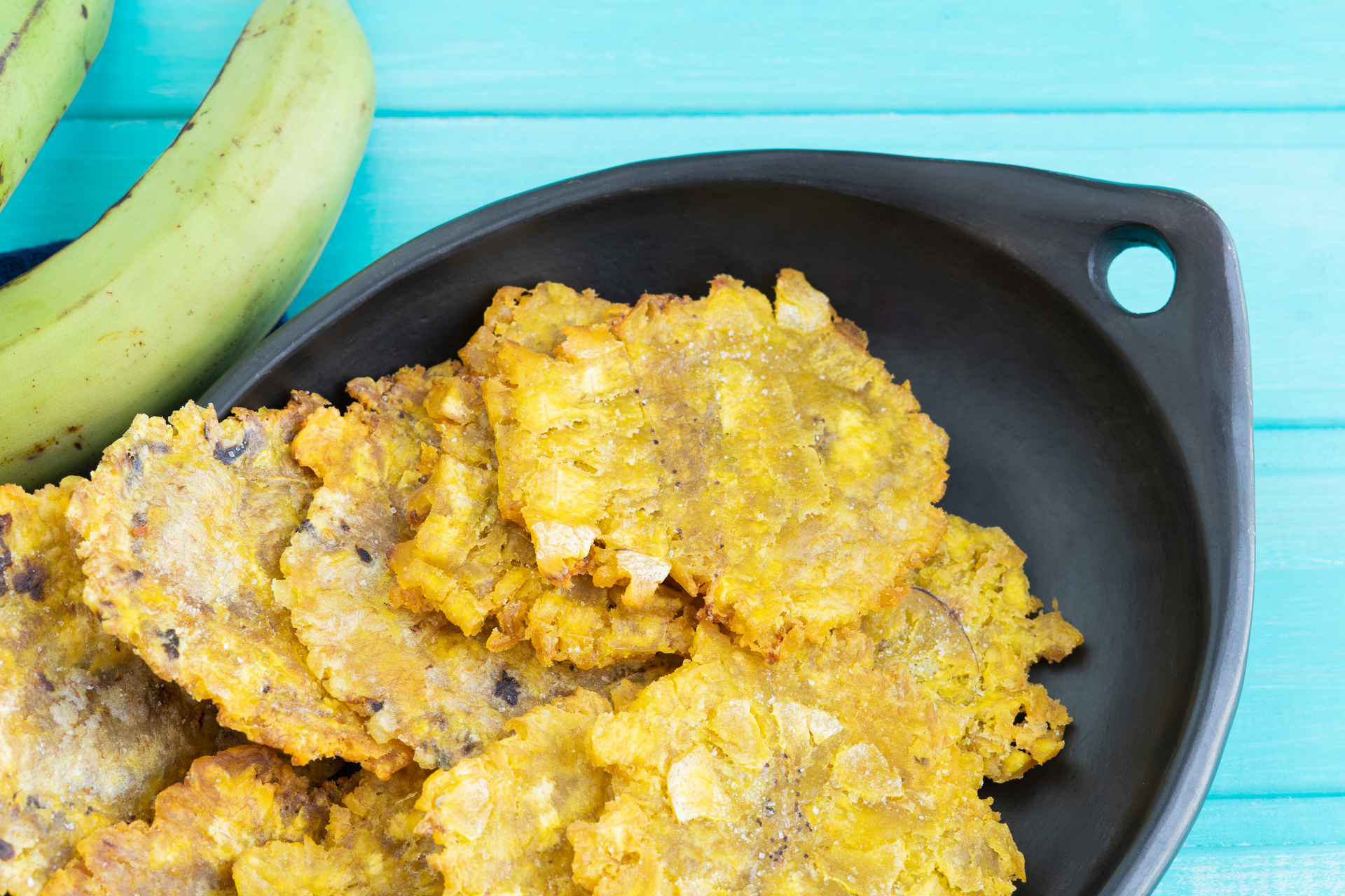 Overhead flat-lay of all ingredients for Cheesy Puerto Rican Bacalaitos with Salted Cod laid out on a kitchen surface.