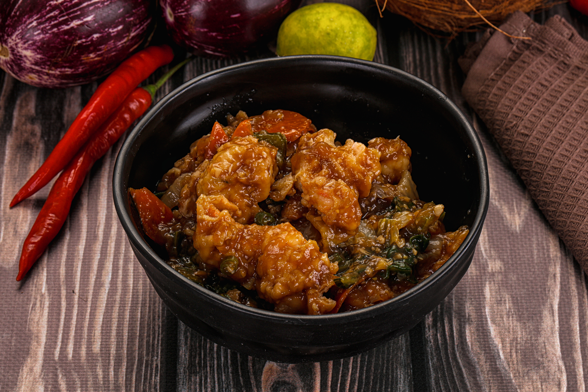 Overhead flat-lay of all ingredients for Chettinad Pepper Chicken laid out on a kitchen surface.