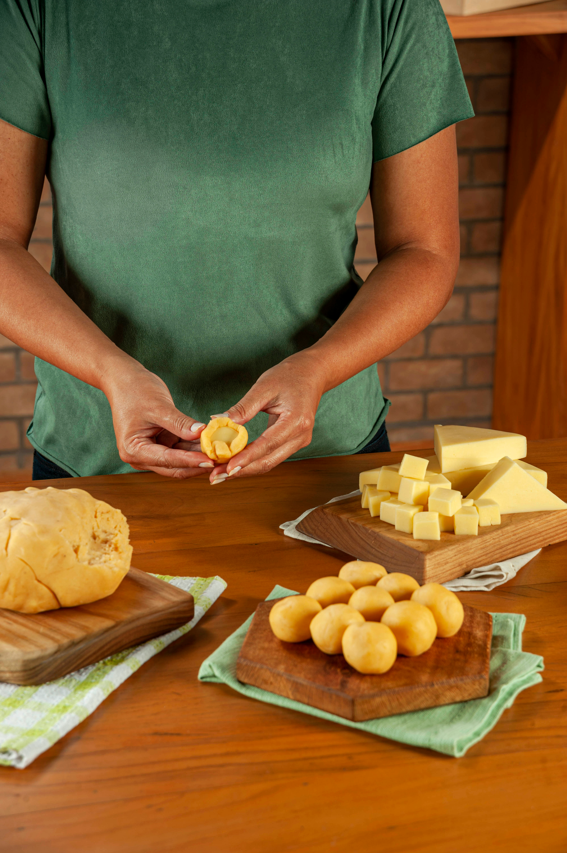 Overhead flat-lay of all ingredients for Chewy Brazilian Pão de Queijo with Cassava Flour laid out on a kitchen surface.