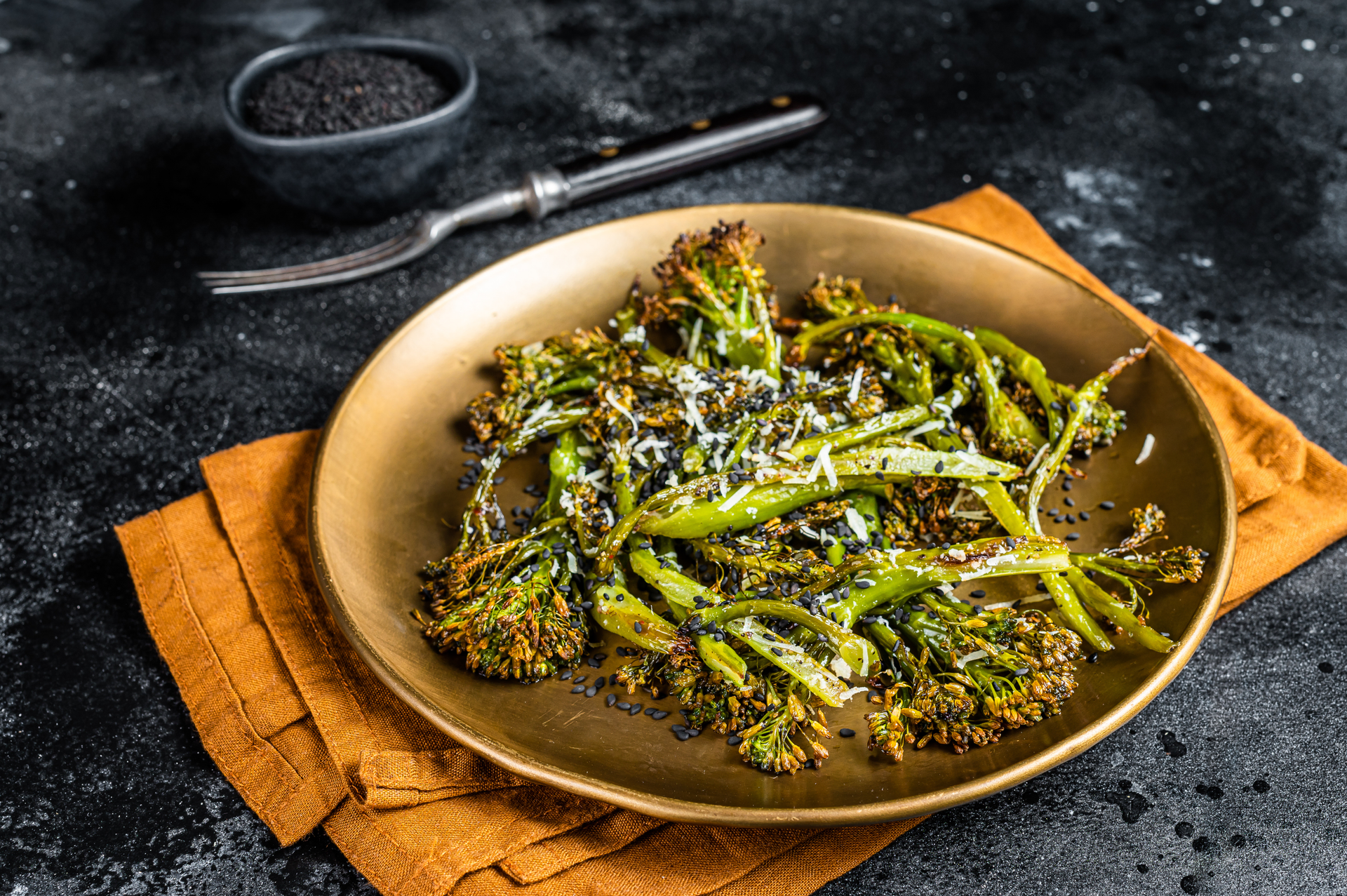 Overhead flat-lay of all ingredients for Chicory Smoked Broccoli with Chili Walnut Pesto laid out on a kitchen surface.