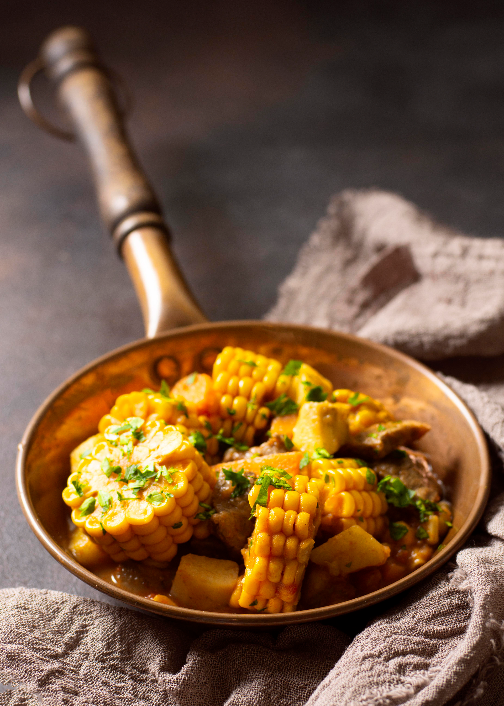 Overhead flat-lay of all ingredients for Chilean Humitas with Corn and Basil laid out on a kitchen surface.