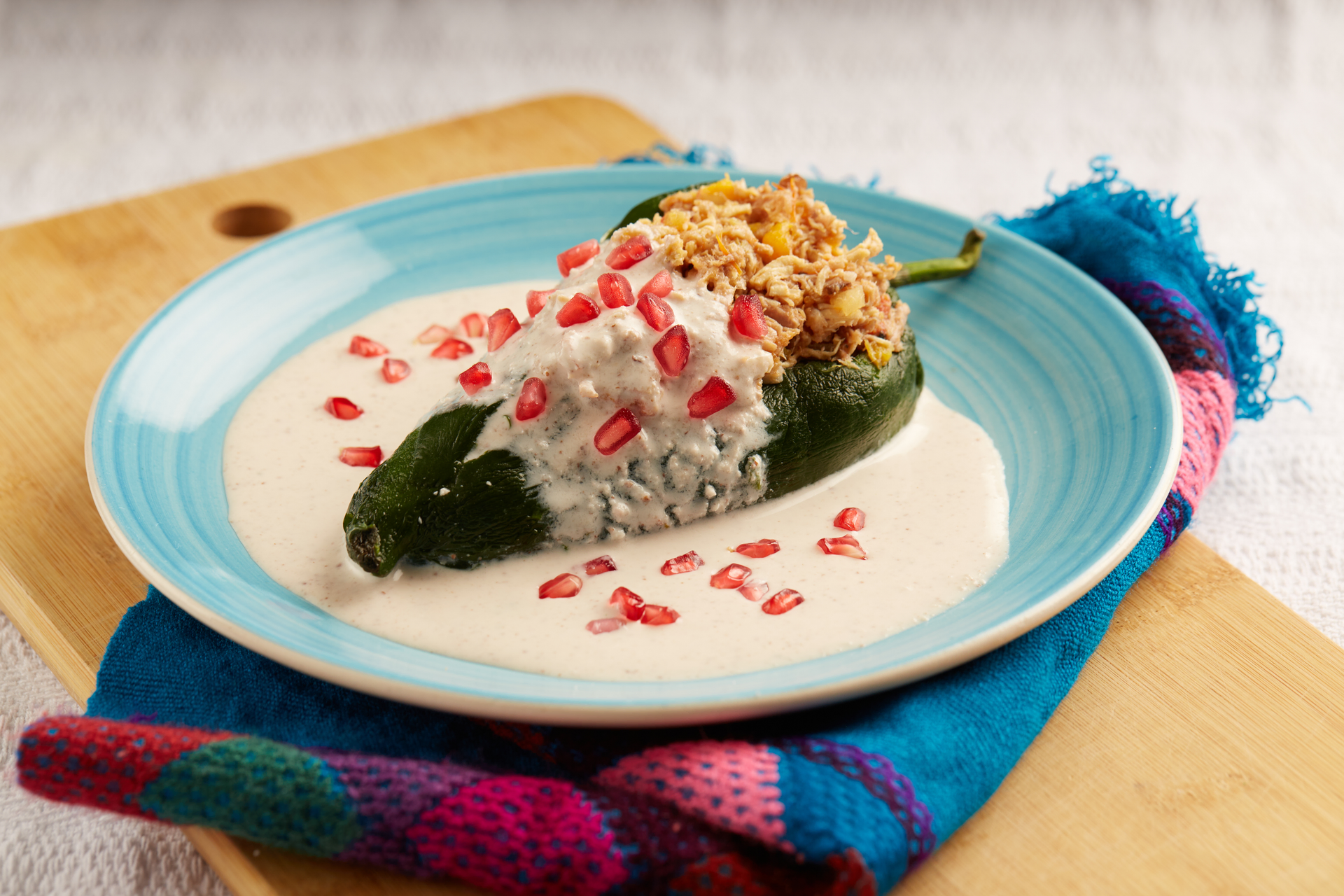 Overhead flat-lay of all ingredients for Chiles en nogada: Authentic Mexican recipe for your home laid out on a kitchen surface.