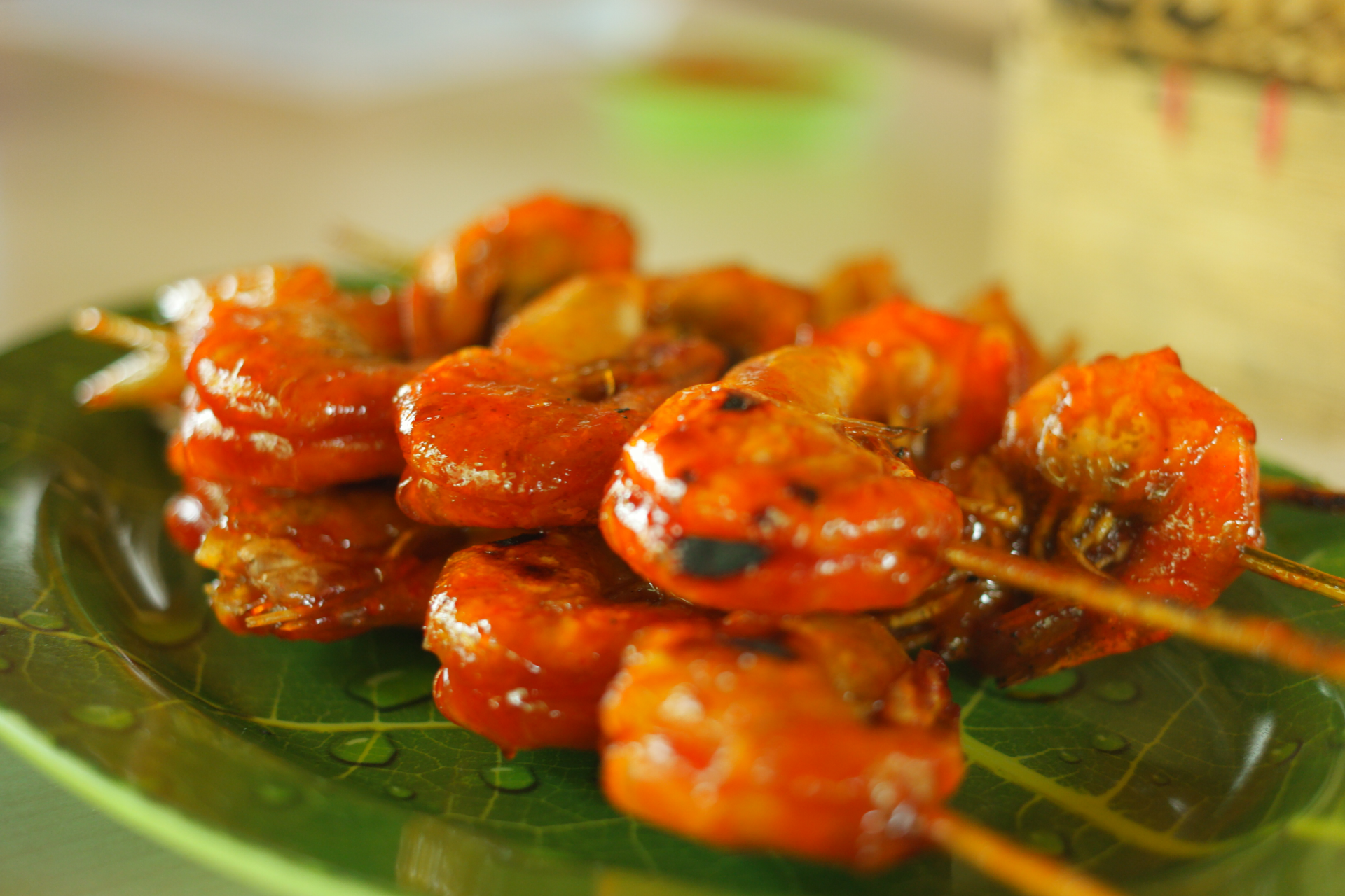 Overhead flat-lay of all ingredients for Citrus-Glazed Malaysian Tamarind Prawns with Lime Leaf laid out on a kitchen surface.